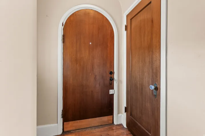 Doorway featuring wood finished floors and arched walkways