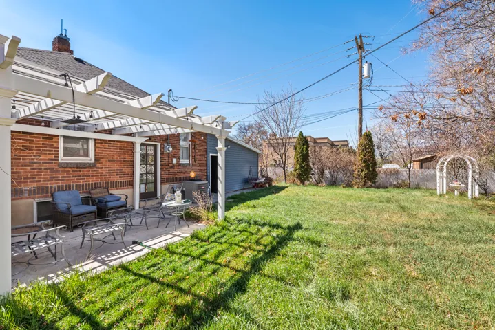 Fenced yard featuring a pergola and a patio