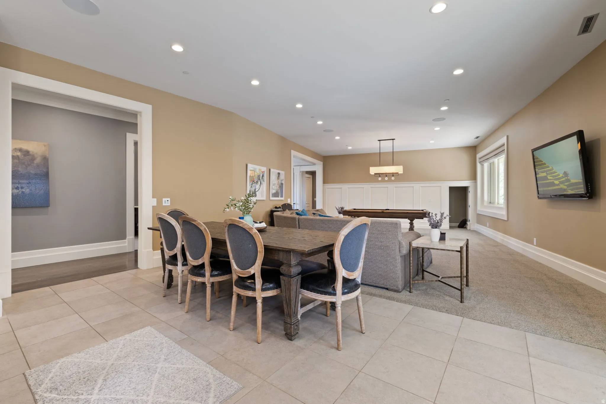 Dining area featuring recessed lighting, light tile patterned floors, and light colored carpet