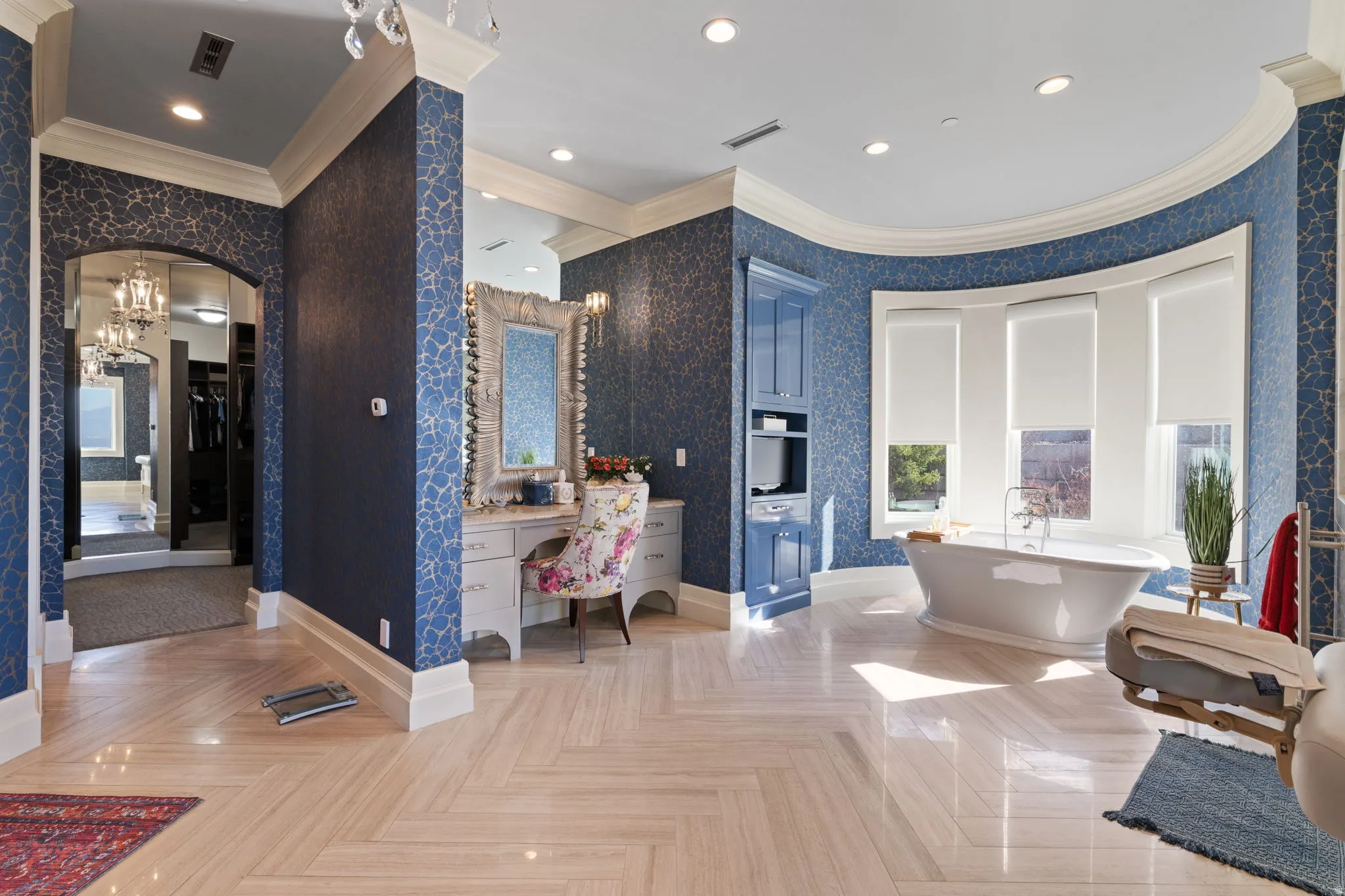 Bathroom with vanity, crown molding, wallpapered walls, parquet flooring, and a soaking tub