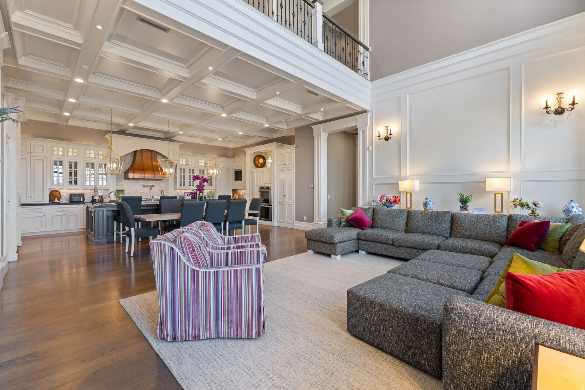 Living area with dark wood-style floors, a decorative wall, recessed lighting, coffered ceiling, and crown molding