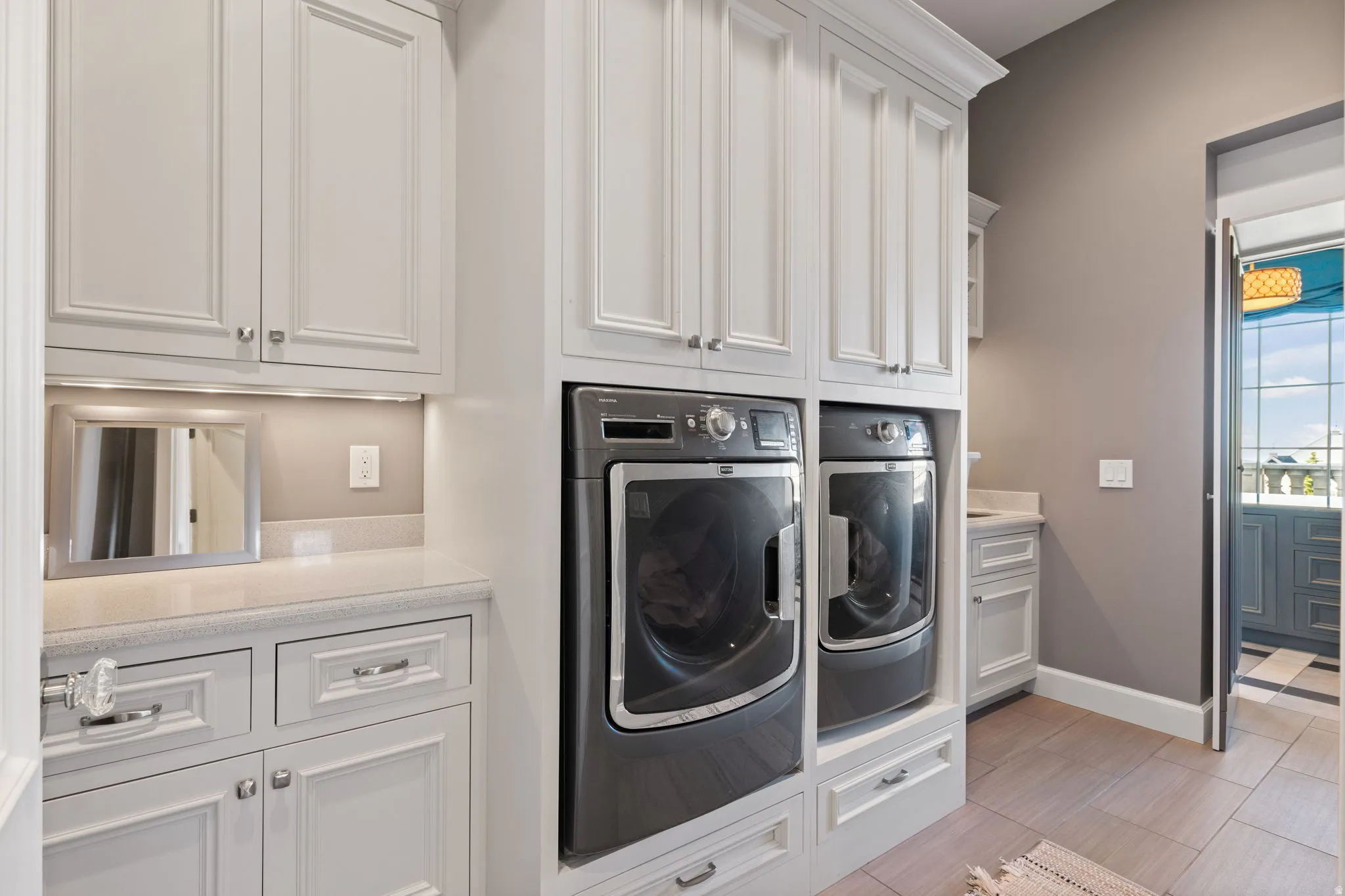 Laundry area with baseboards and washer and clothes dryer
