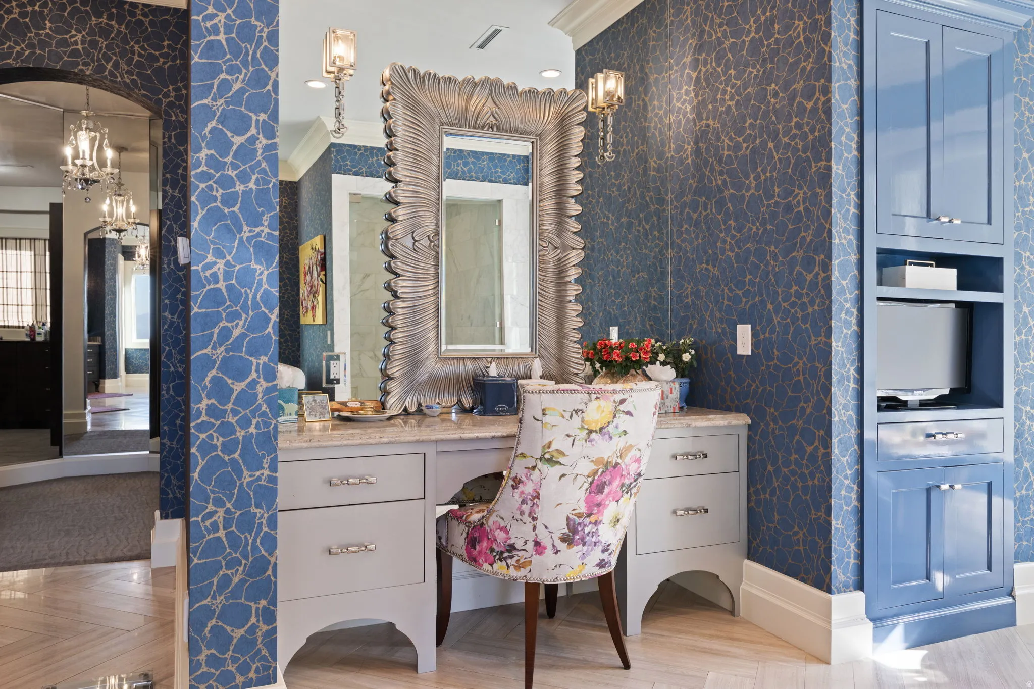 Bathroom with wallpapered walls, suspended lighting, parquet floors, crown molding, and vanity