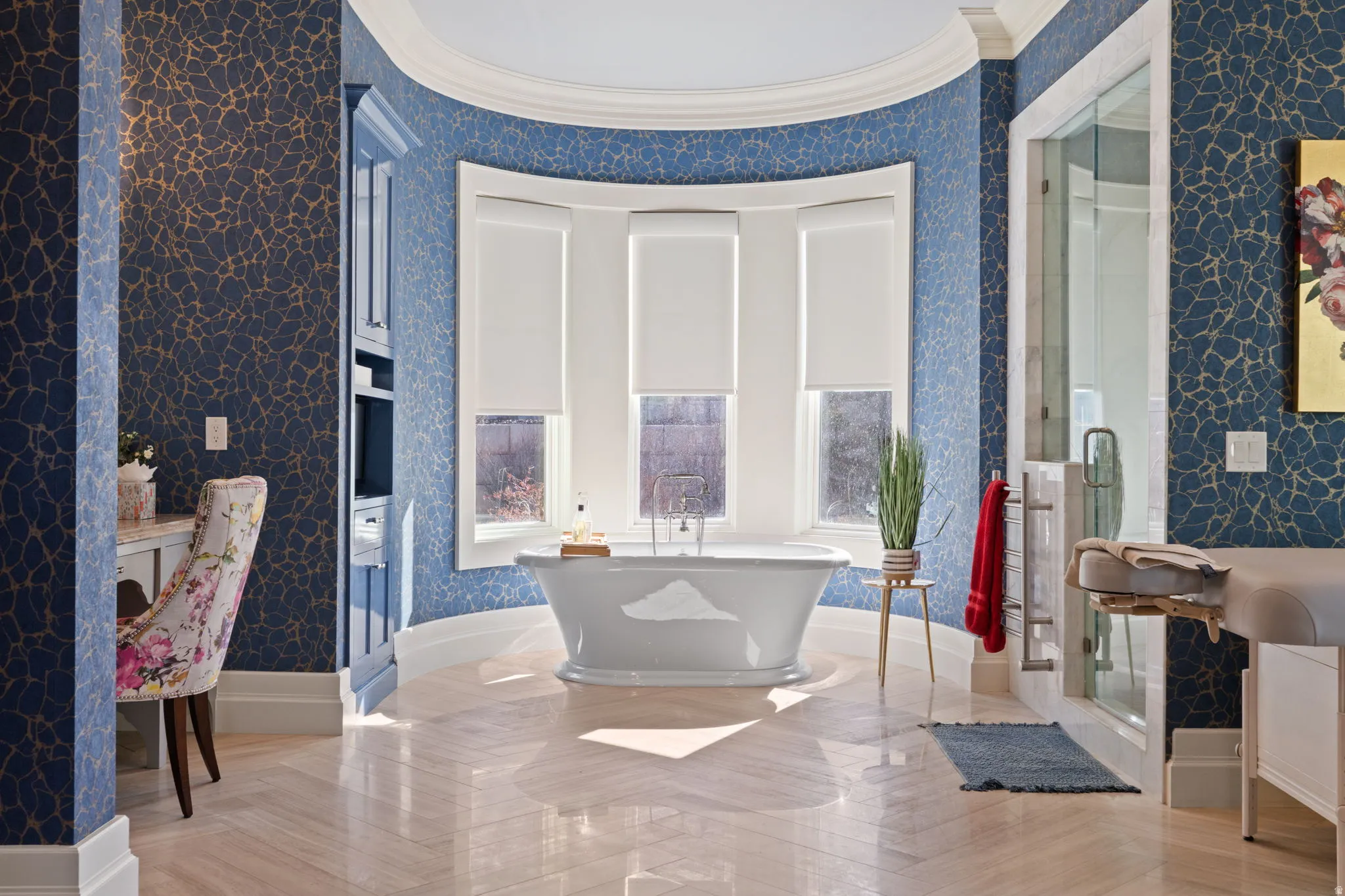 Full bath featuring crown molding, a freestanding tub, a stall shower, vanity, and parquet floors