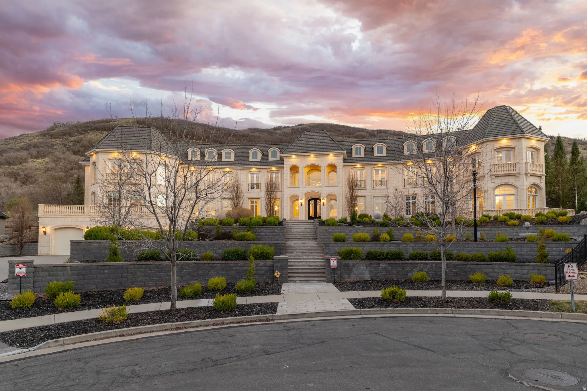 View of front of house with stone siding and a fenced front yard