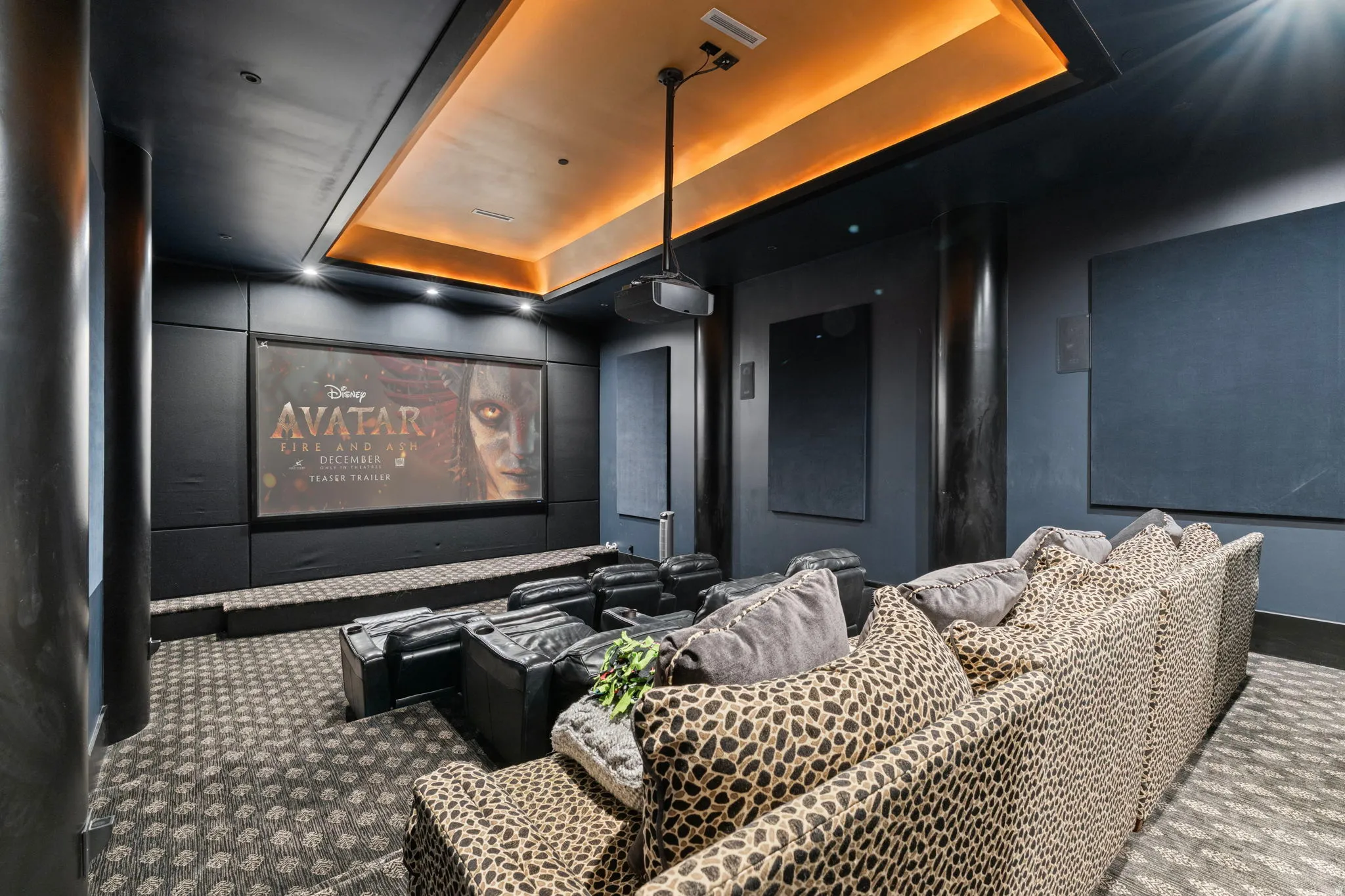 Home theater room featuring a raised ceiling