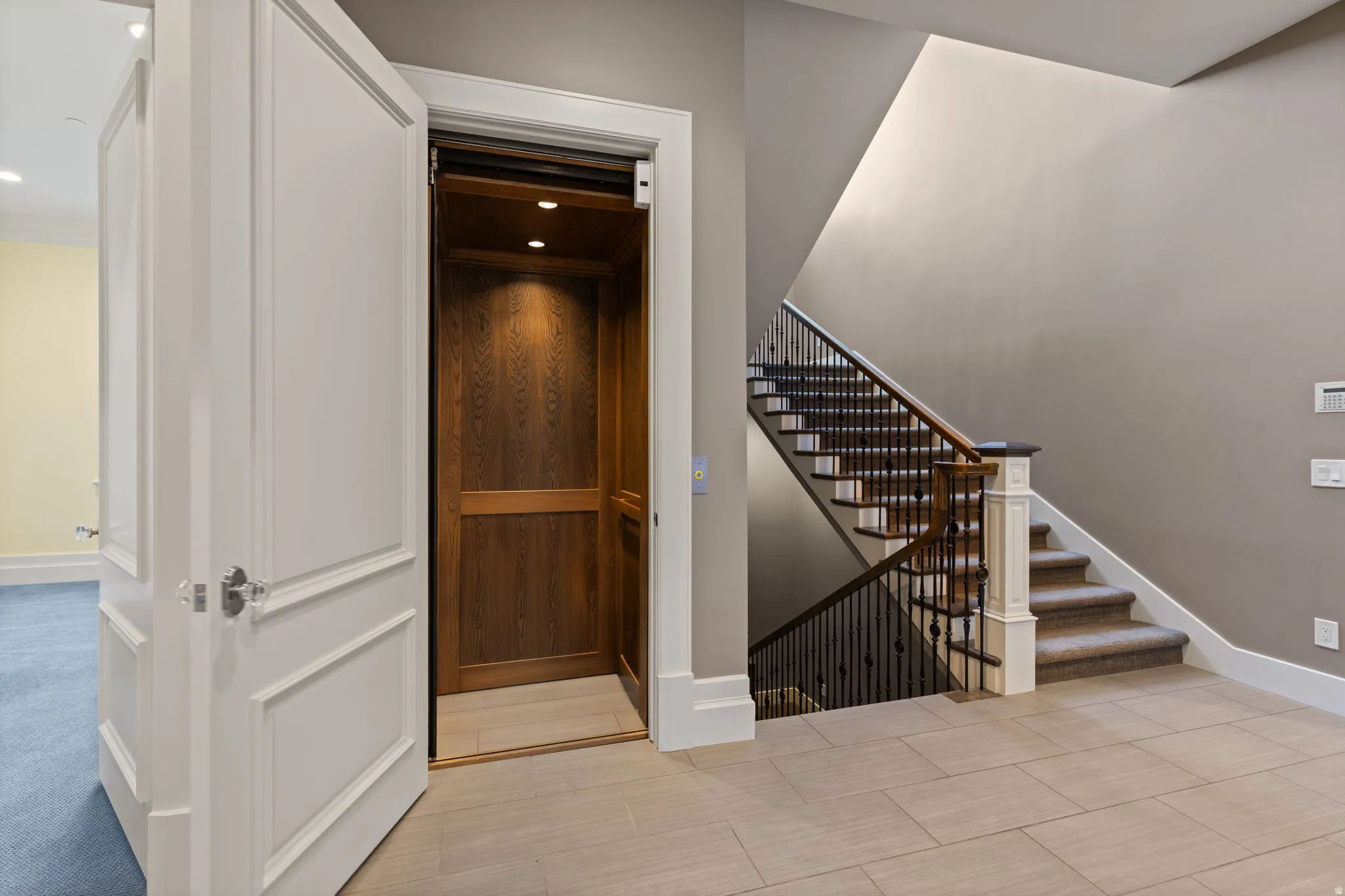 Stairway featuring baseboards and elevator