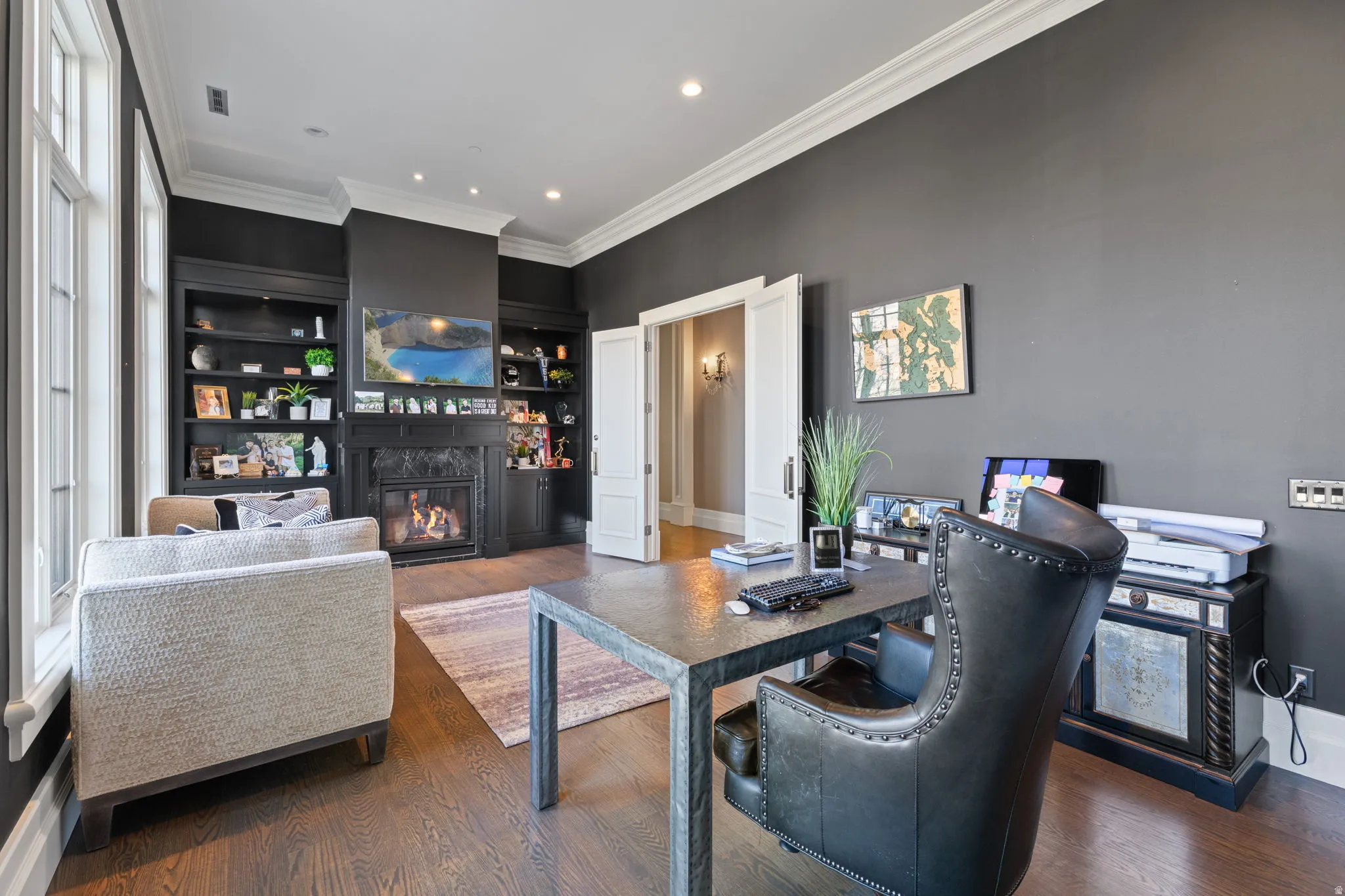 Office with ornamental molding, a high end fireplace, dark wood-style flooring, built in shelves, and recessed lighting