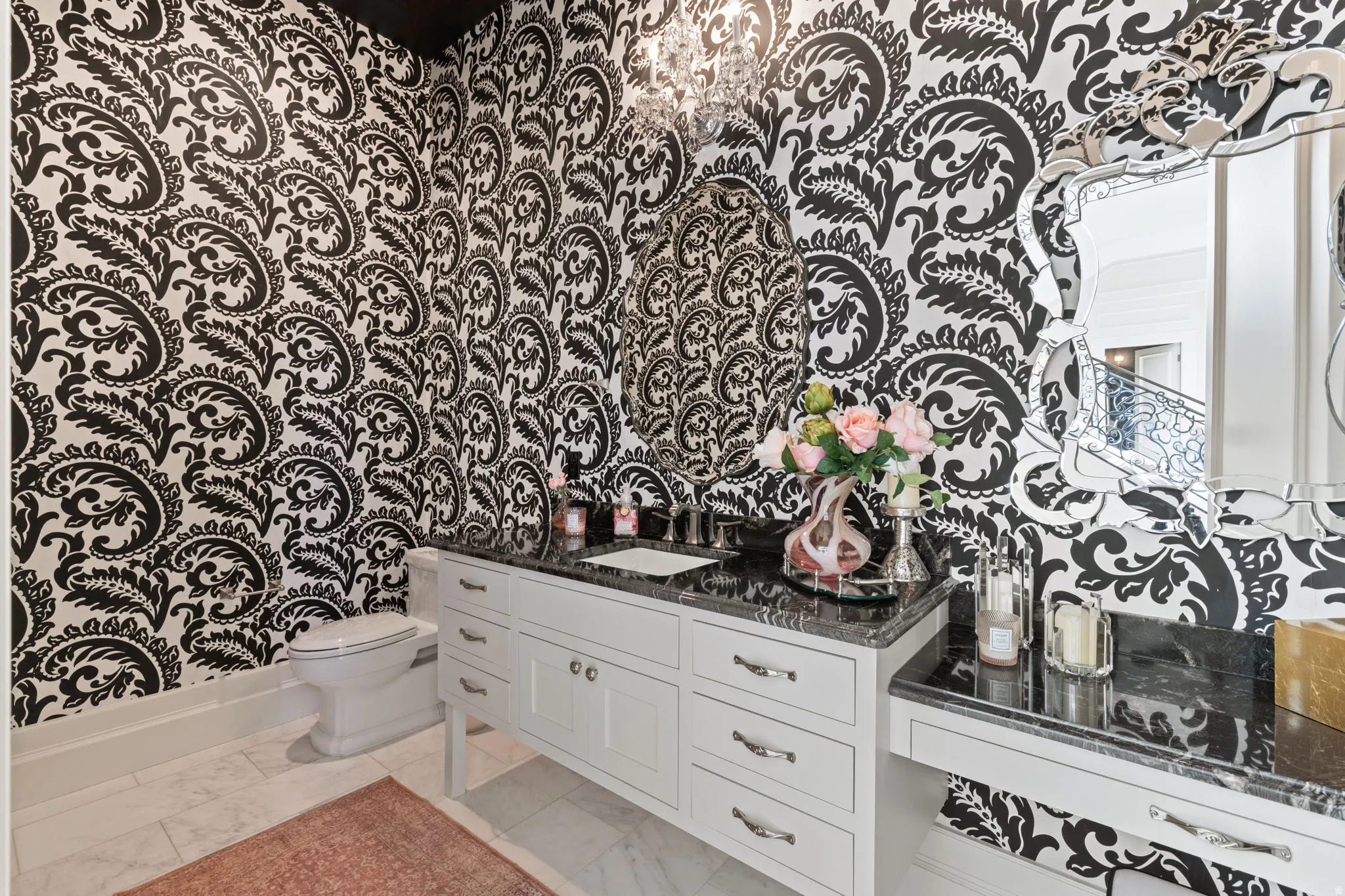 Half bathroom featuring vanity and light marble finish floors