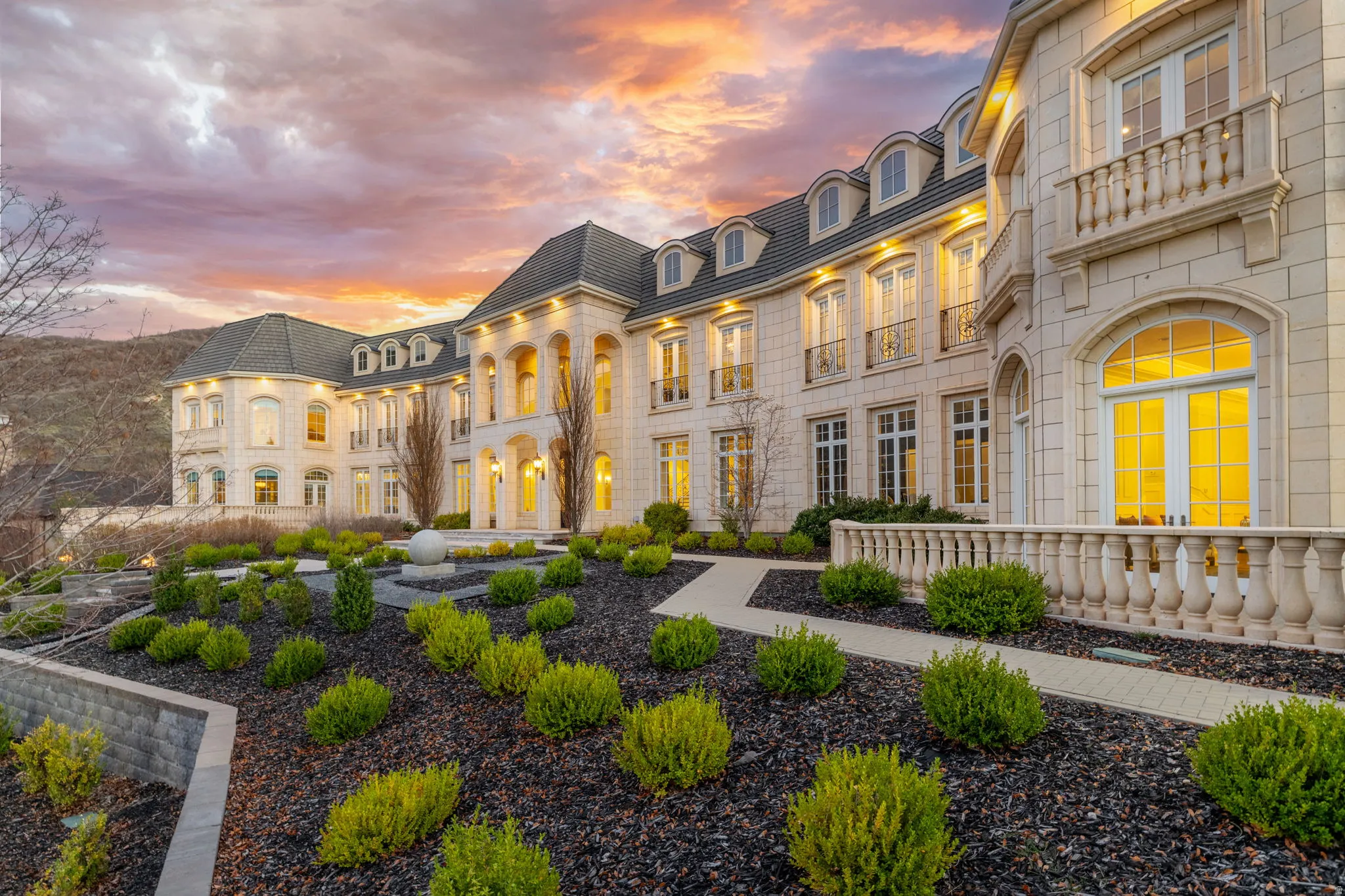 Rear view of property featuring mansard roof