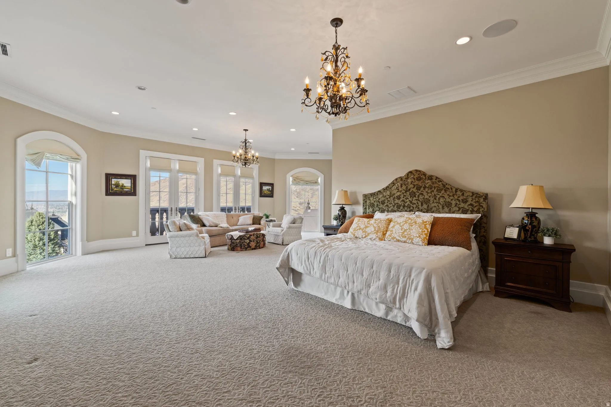 Bedroom featuring a chandelier, ornamental molding, light colored carpet, and access to outside