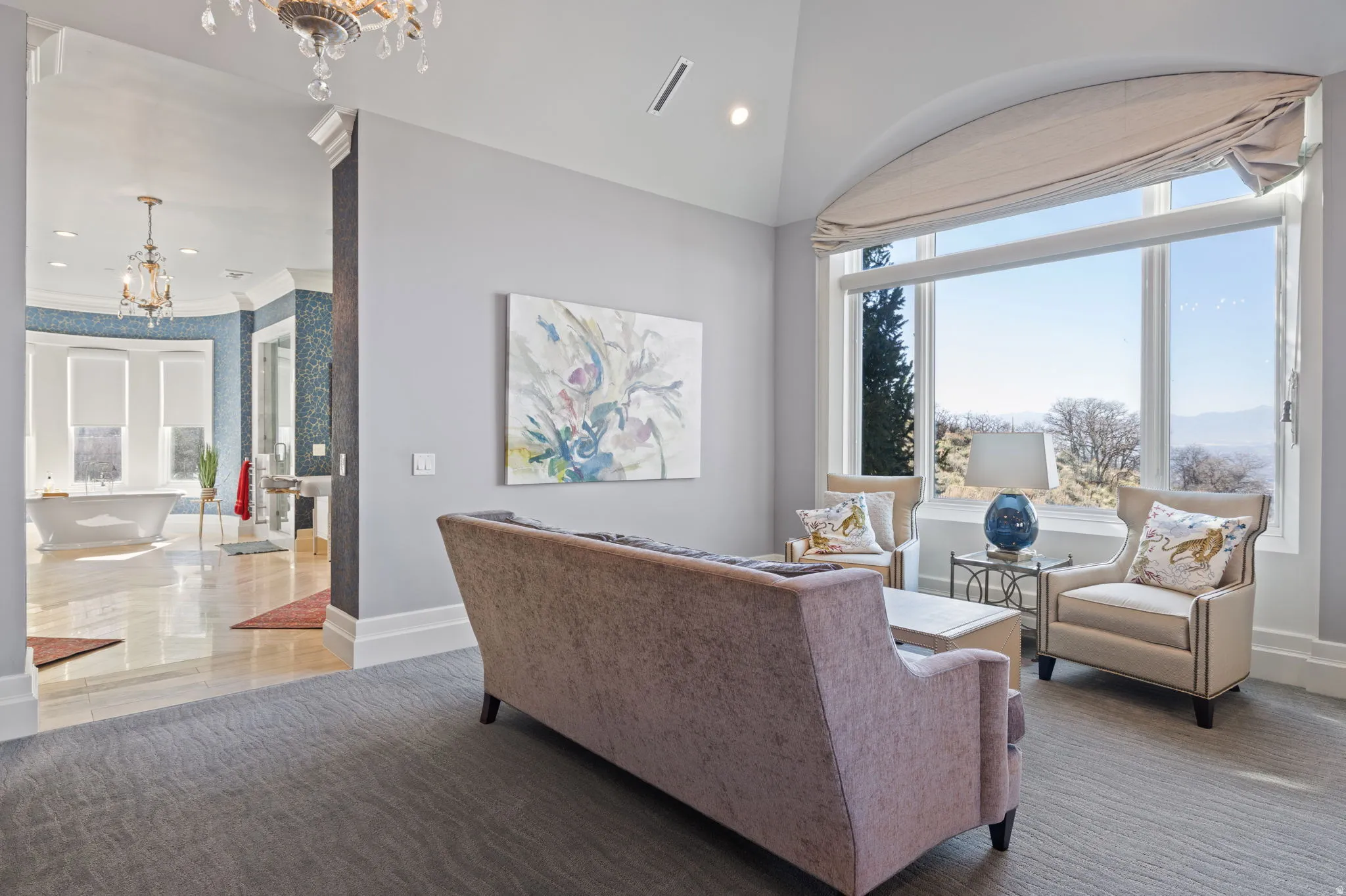 Living area featuring a chandelier and plenty of natural light