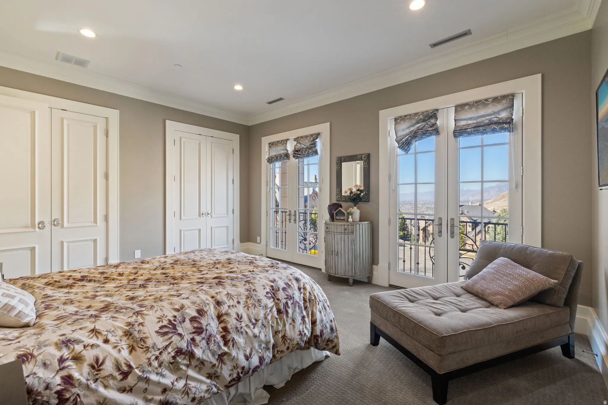Bedroom with multiple closets, access to outside, ornamental molding, carpet floors, and radiator