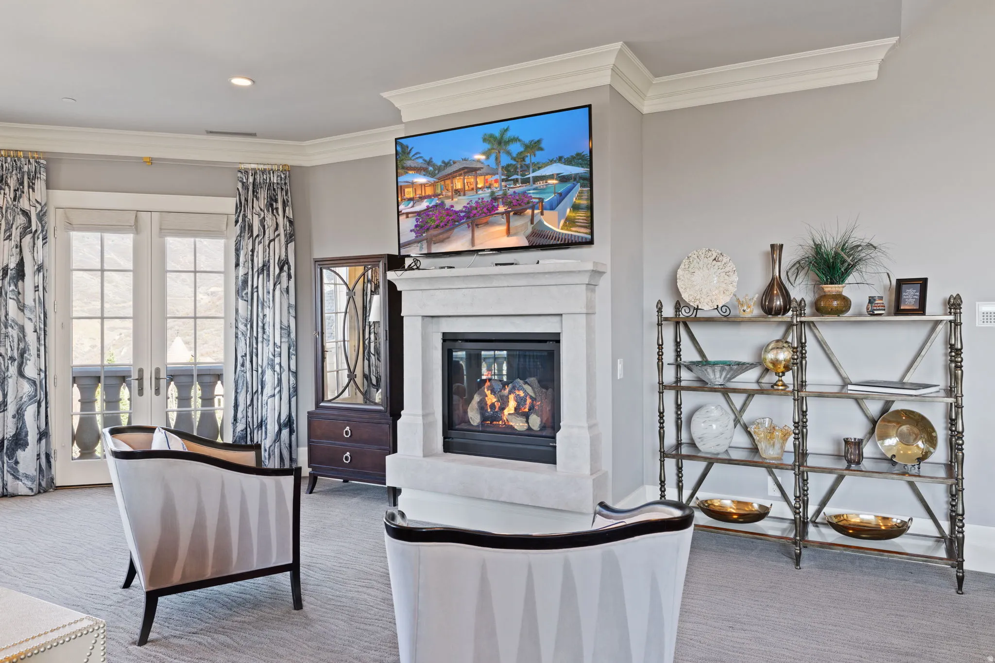 Living room with carpet, crown molding, a glass covered fireplace, recessed lighting, and french doors