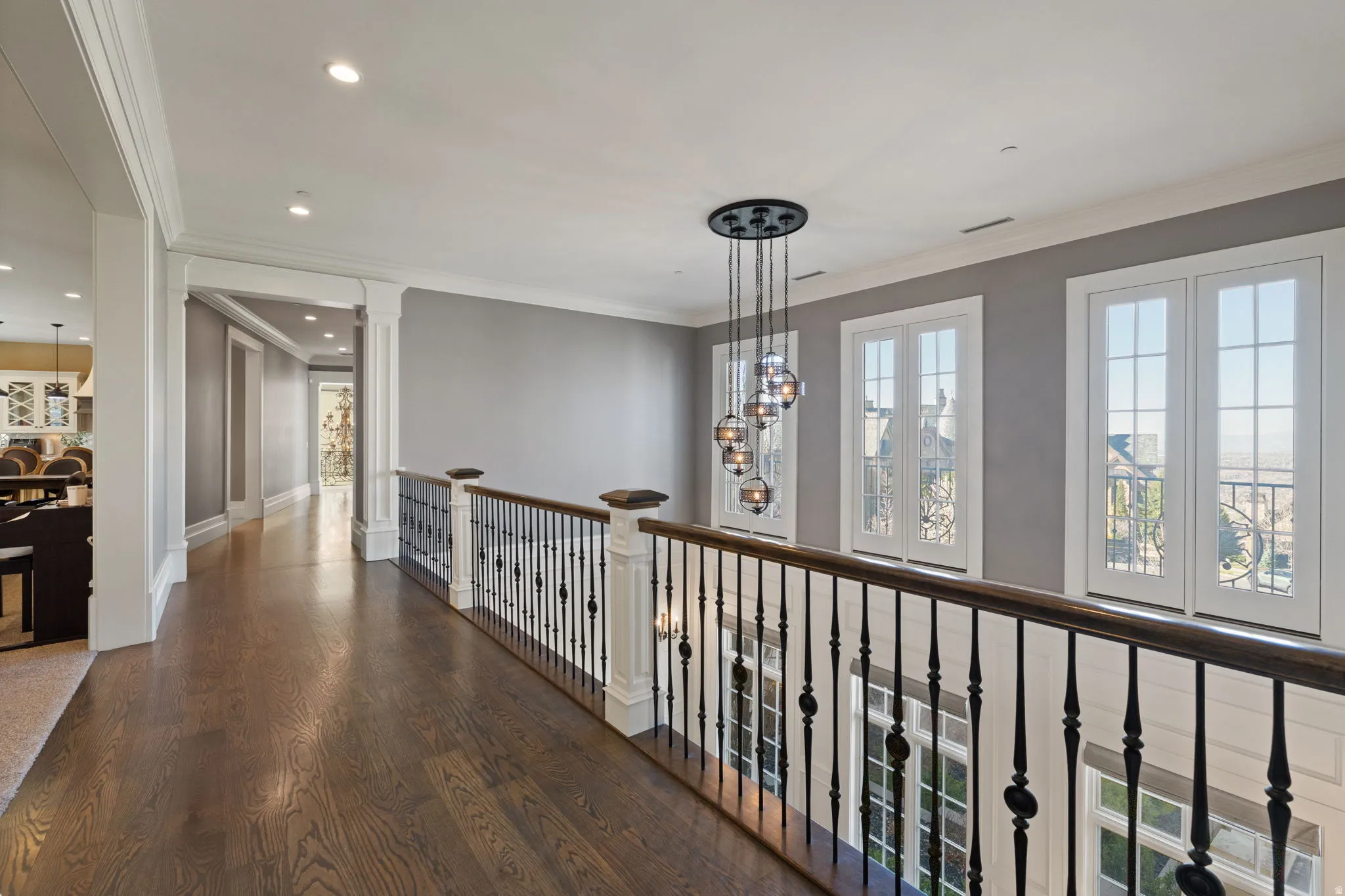 Hallway featuring dark wood-type flooring, crown molding, and recessed lighting