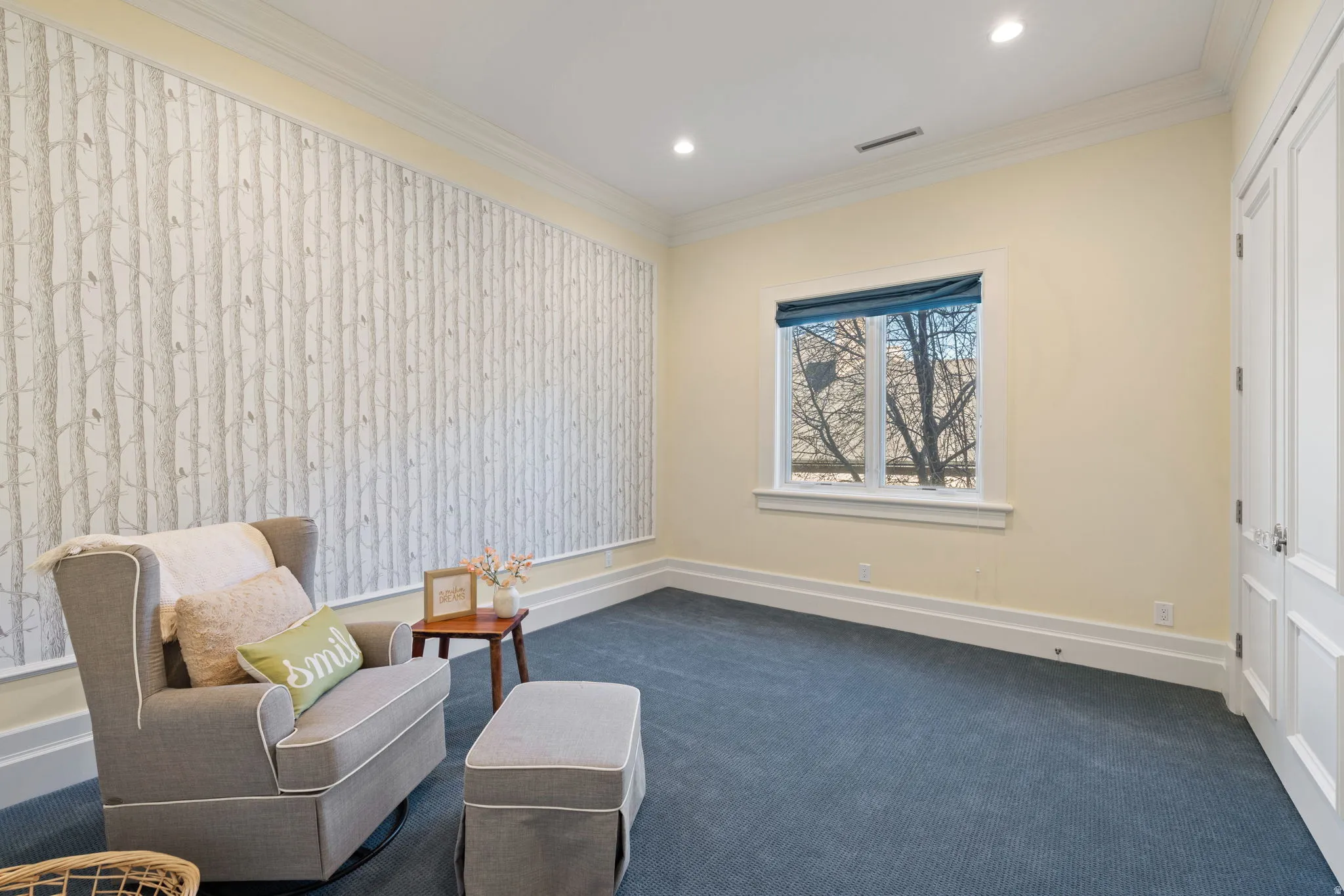 Sitting room with dark carpet, crown molding, and recessed lighting