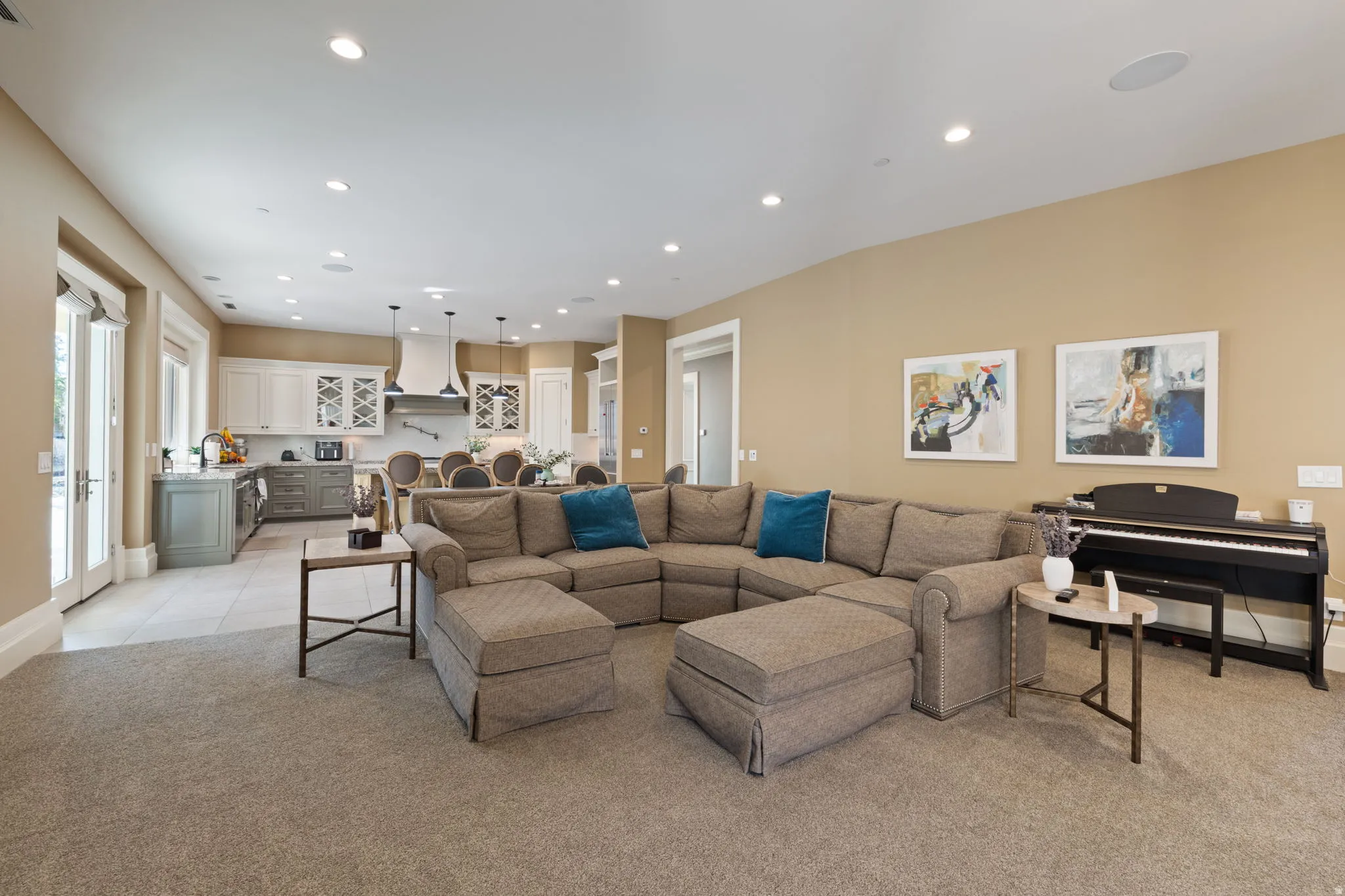 Living area with recessed lighting and light carpet