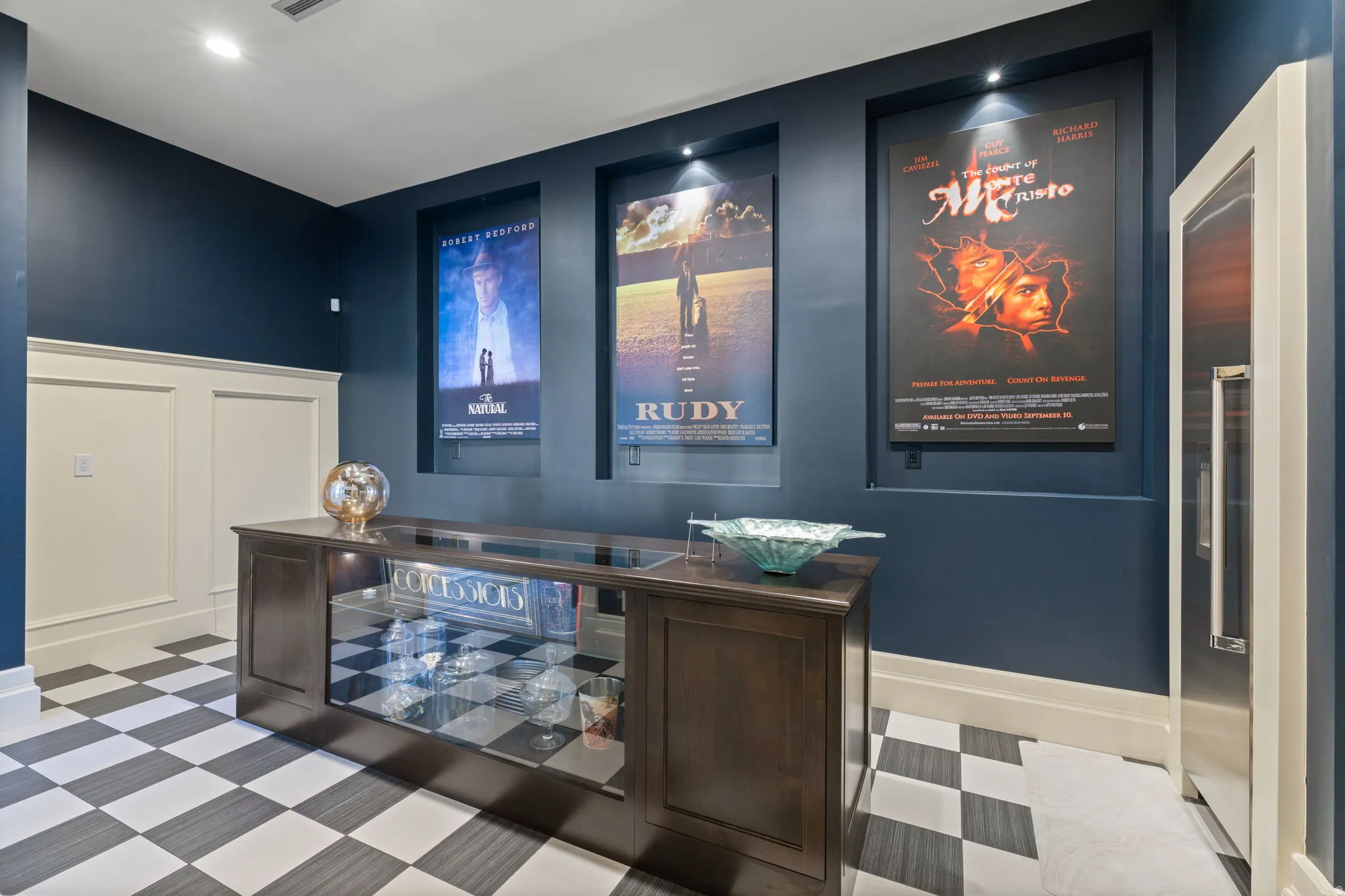 Home theater room featuring a decorative wall, light floors, and recessed lighting