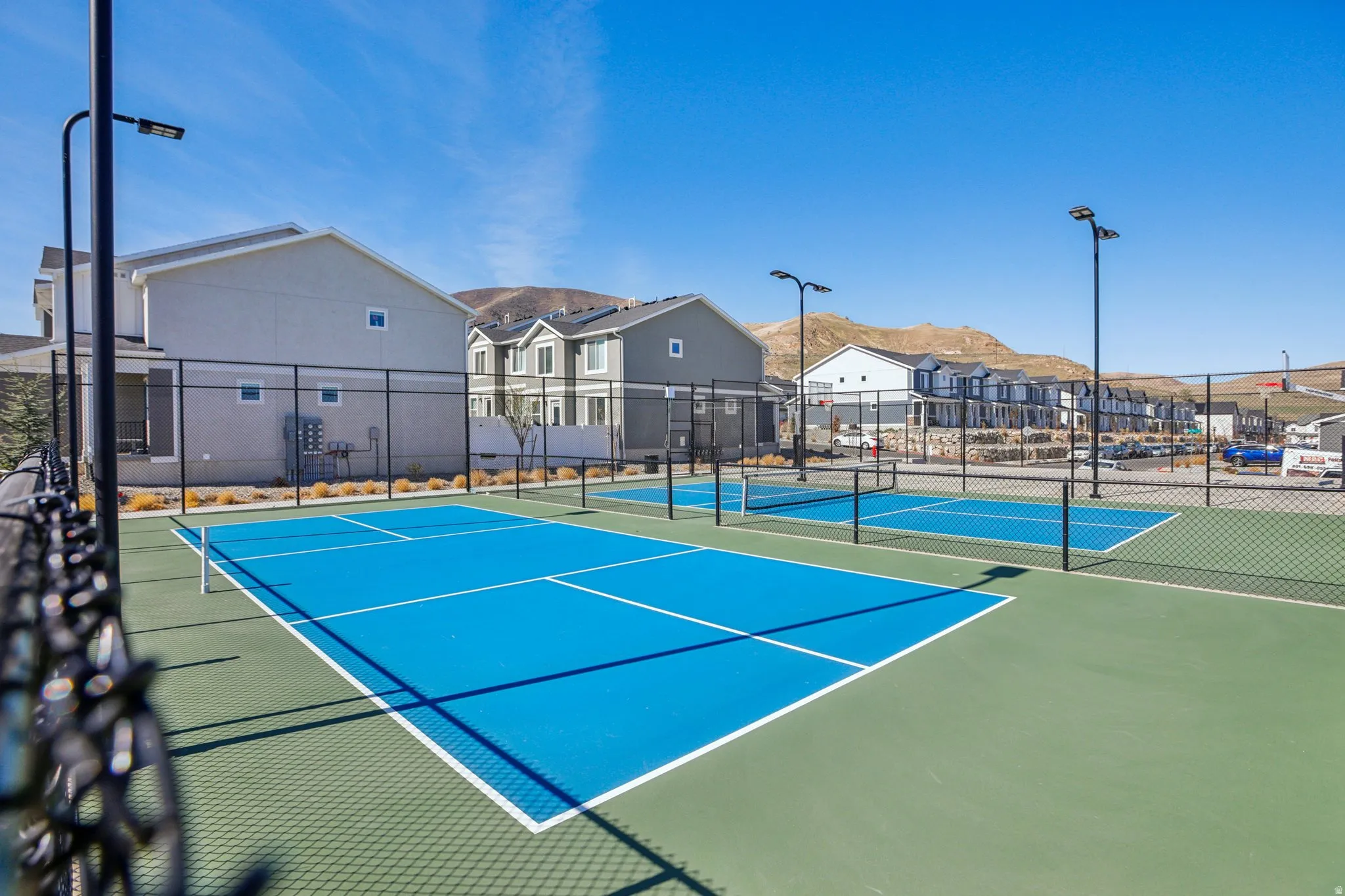 View of tennis court featuring a residential view