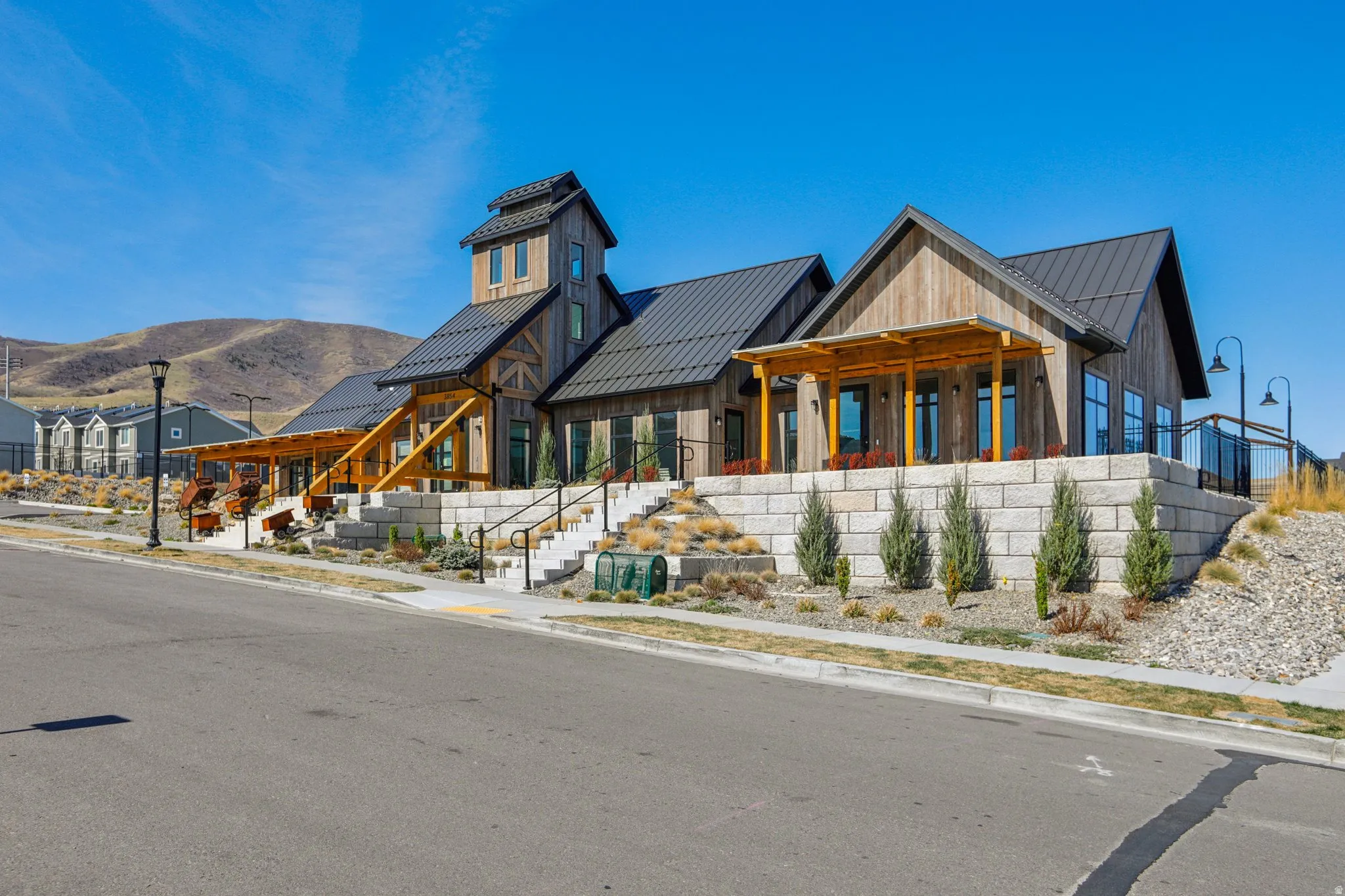 View of front of home featuring a standing seam roof, a porch, a mountain view, and board and batten siding