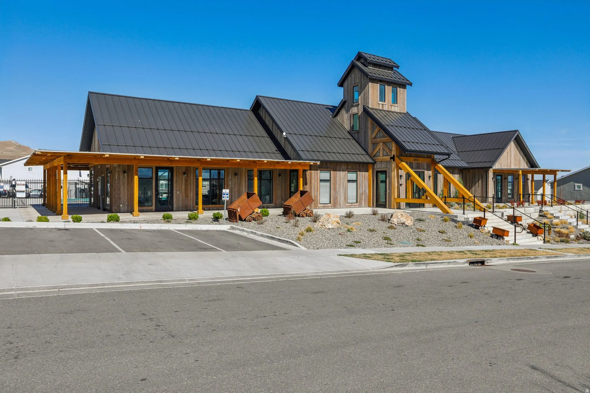 View of building exterior featuring uncovered parking