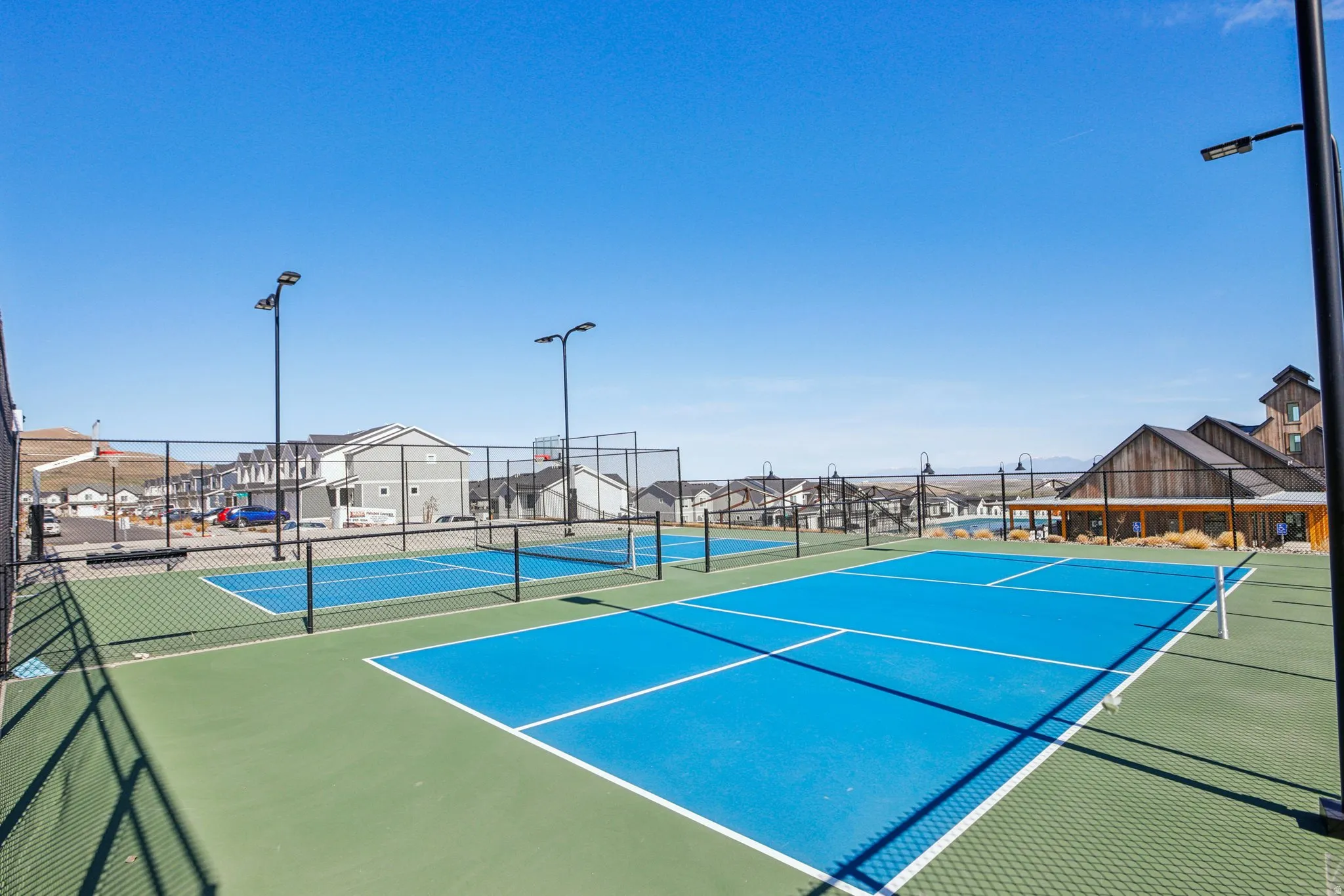 View of tennis court featuring a residential view