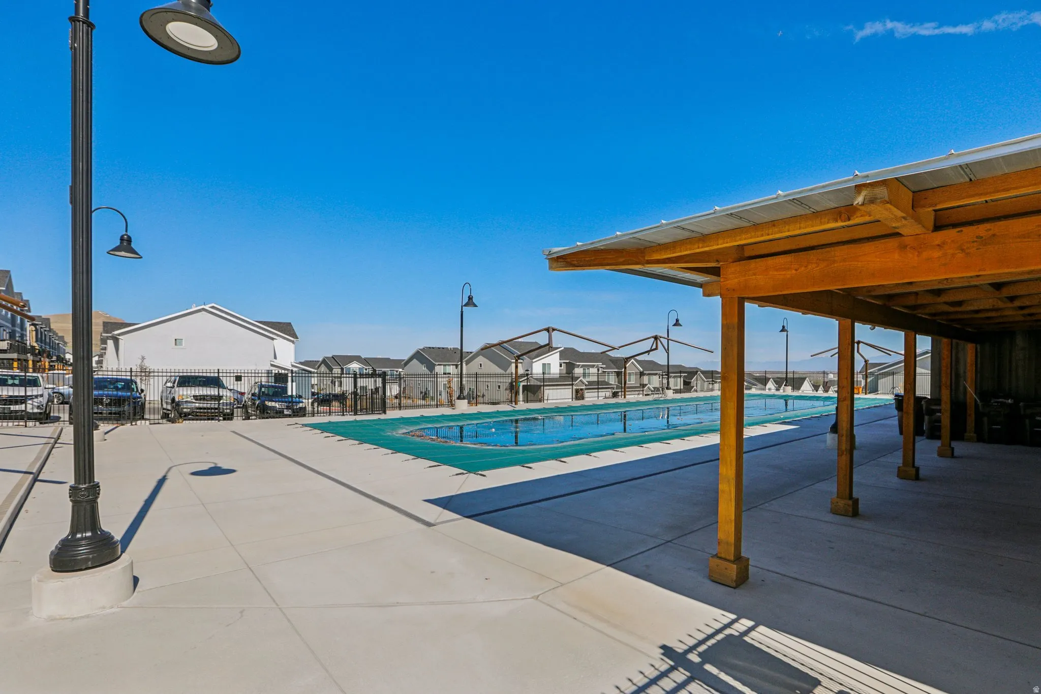 Community pool with a patio and a residential view