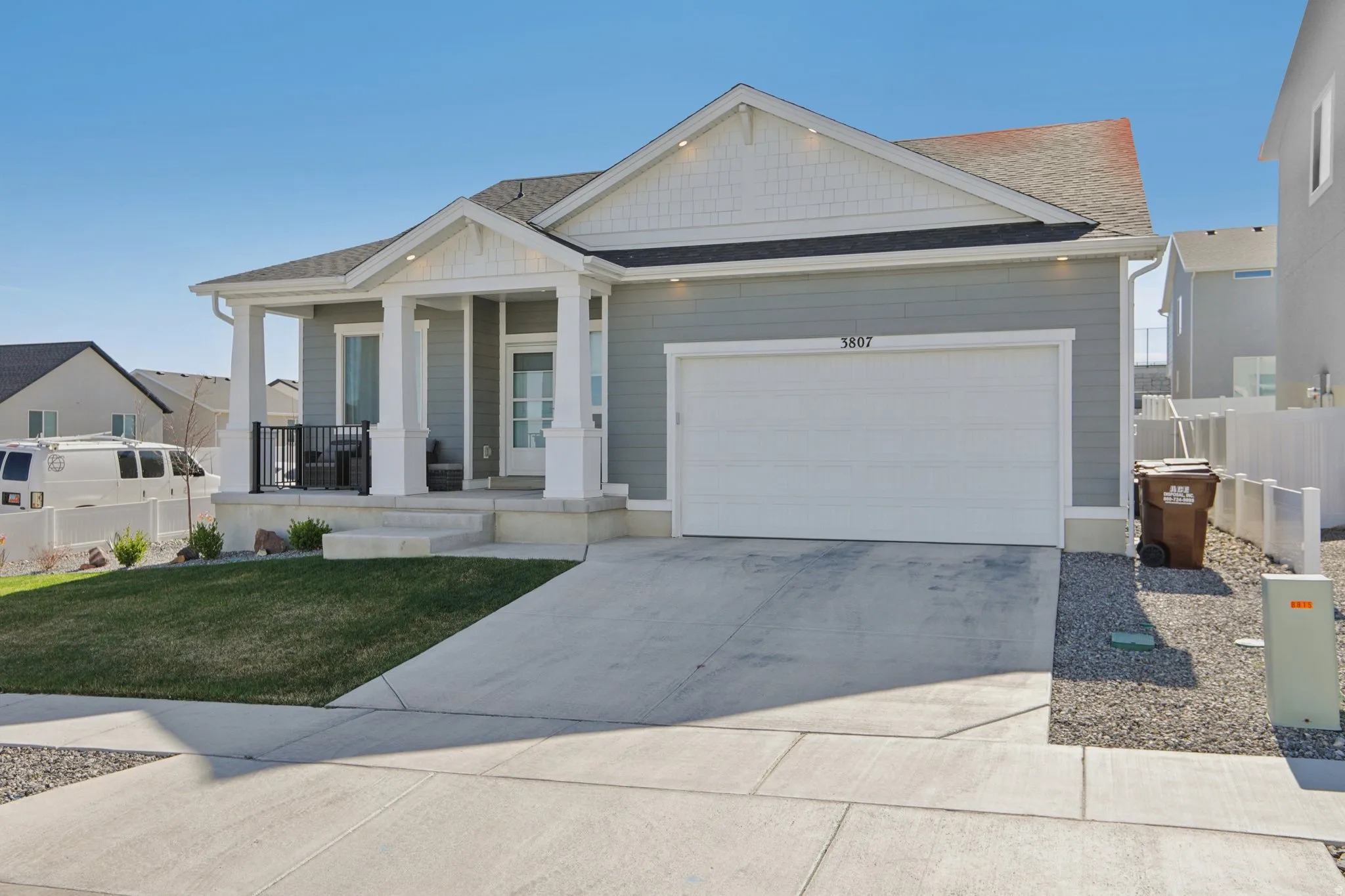 Craftsman house featuring a porch, a garage, concrete driveway, and roof with shingles
