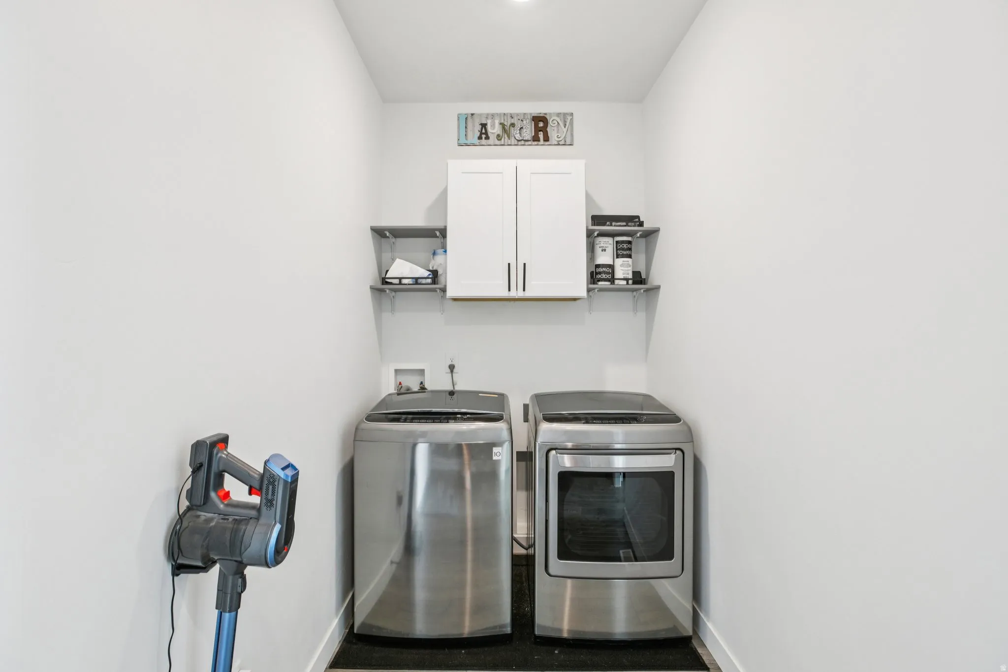 Laundry room with cabinet space and independent washer and dryer