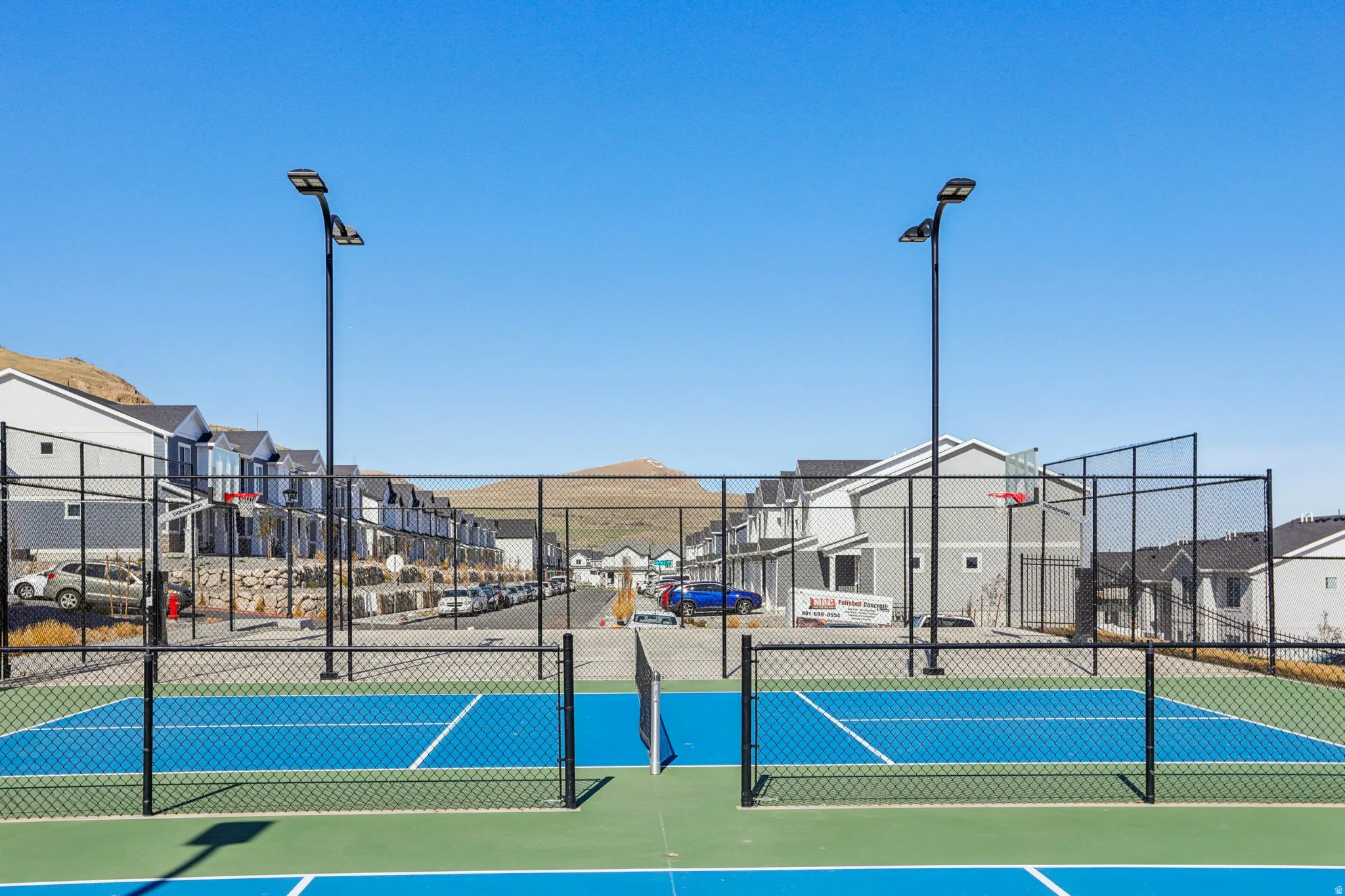 View of sport court with a residential view, community basketball court, and a tennis court