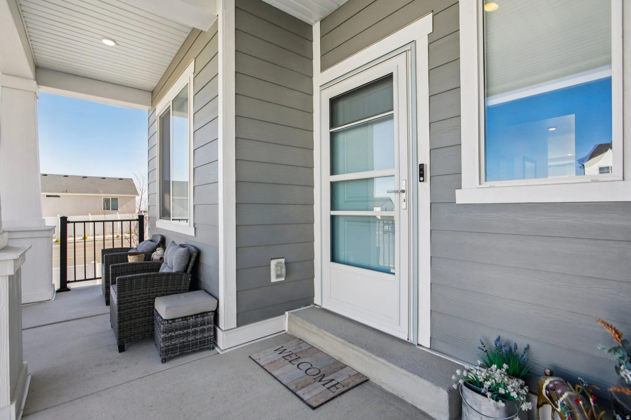 Doorway to property featuring covered porch