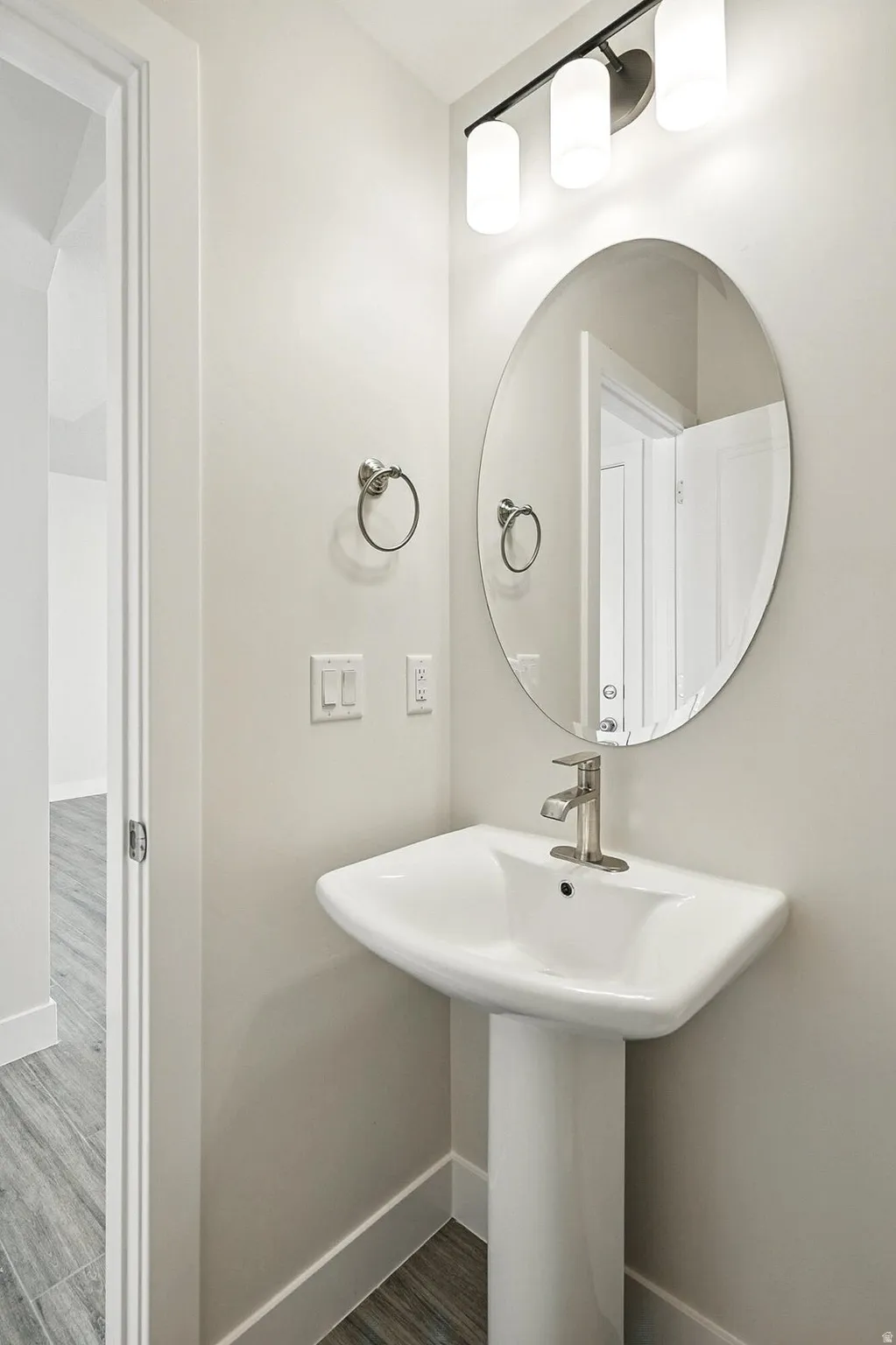 Bathroom with baseboards and wood finished floors
