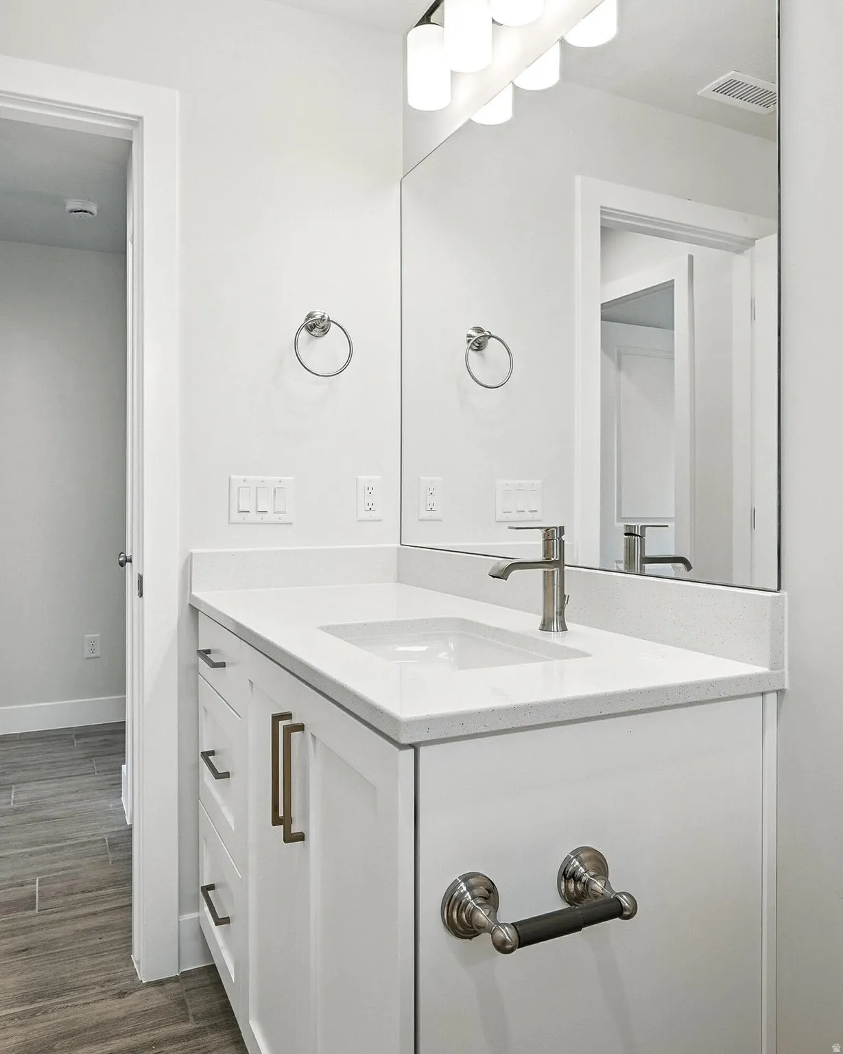 Bathroom with vanity and dark wood-style floors