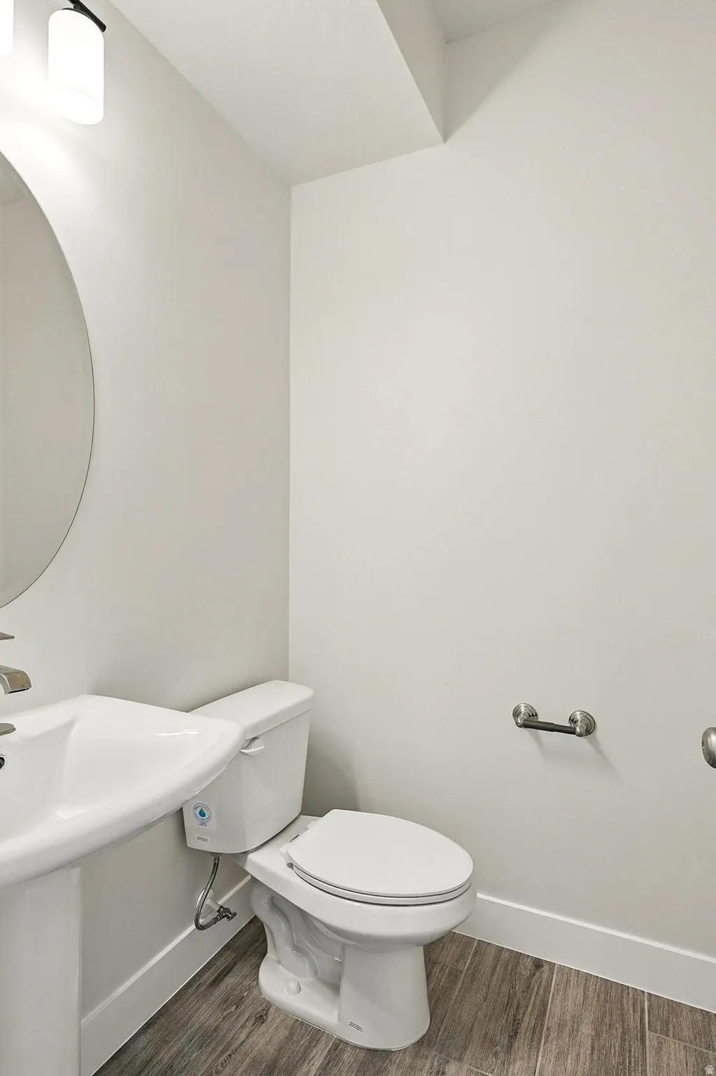 Half bath featuring dark wood-type flooring
