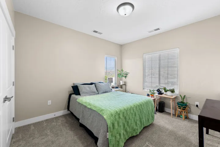 Bedroom featuring carpet flooring and baseboards