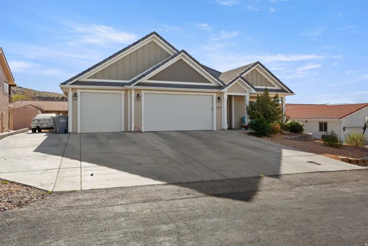 Craftsman house featuring board and batten siding, a garage, and concrete driveway