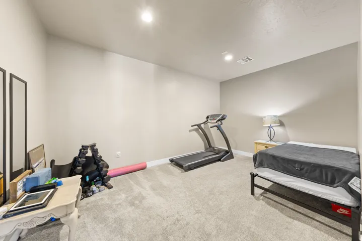 Workout area featuring light carpet and recessed lighting