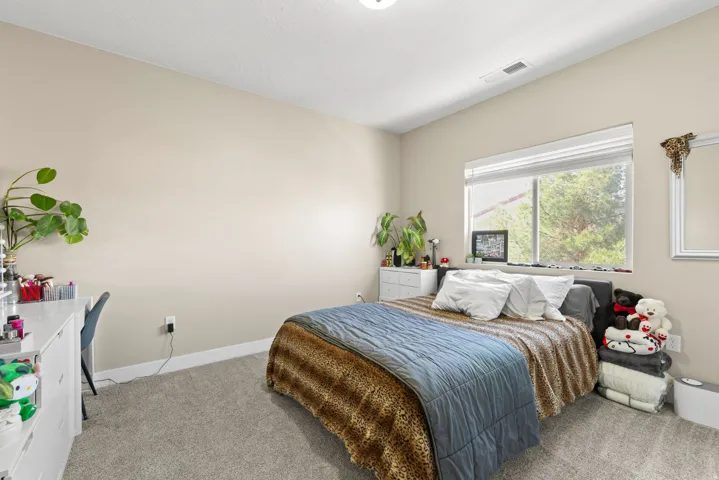 Bedroom with light colored carpet