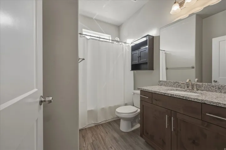 Full bathroom featuring vanity, light wood-style floors, and shower / bath combination