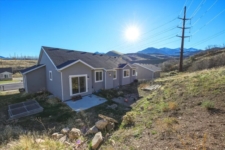 Back of house featuring a patio and a mountain view