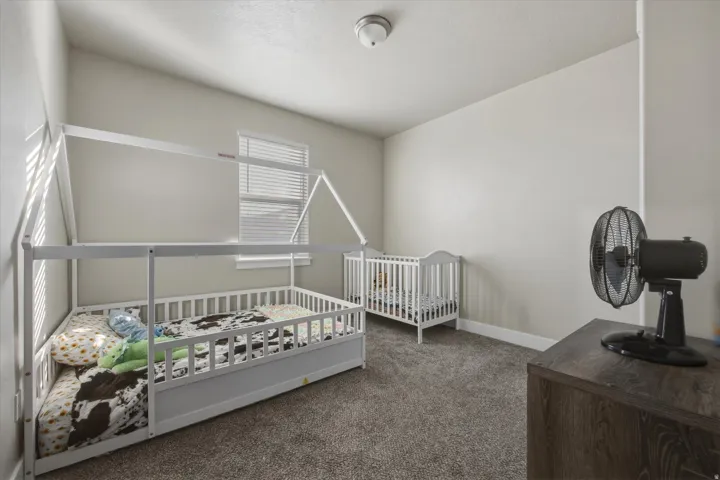 Bedroom with carpet and window