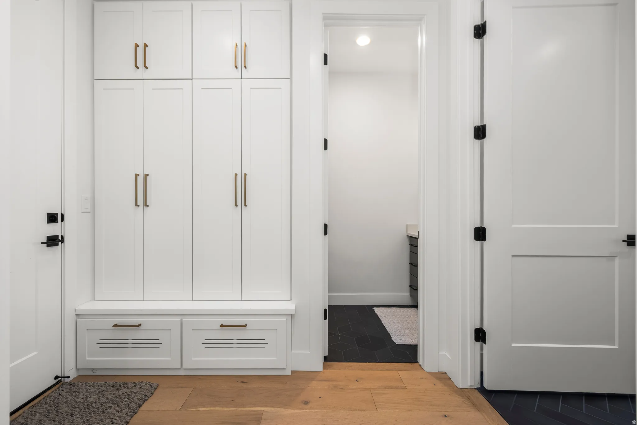 Mudroom with light wood-type flooring and recessed lighting