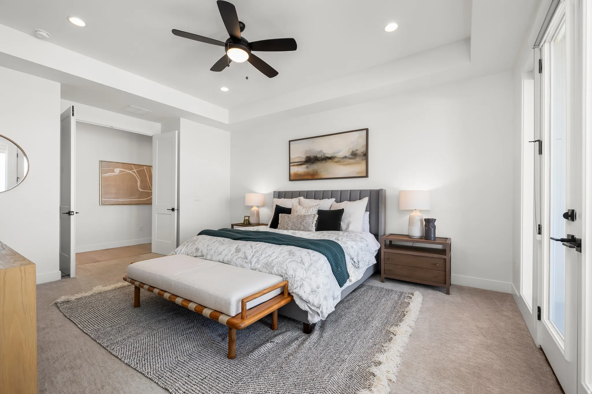 Bedroom featuring light colored carpet, ceiling fan, a raised ceiling, and recessed lighting