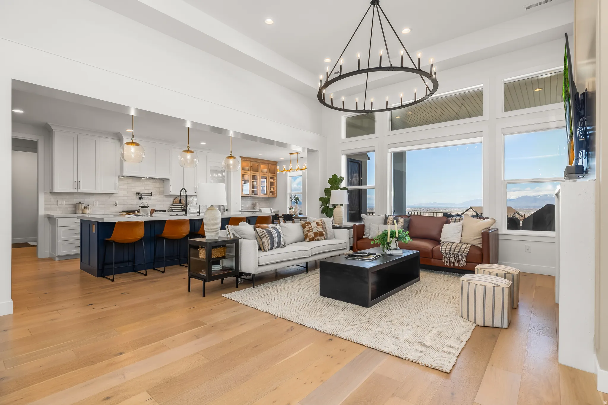 Living room with light wood-style floors and a chandelier