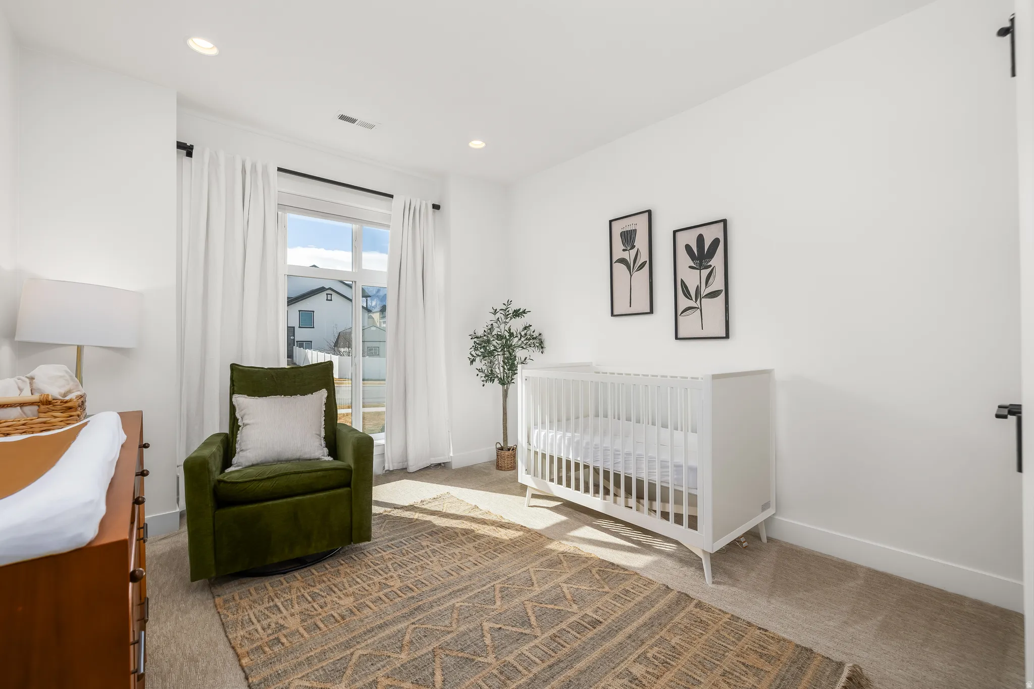 Bedroom featuring a nursery area, carpet flooring, and recessed lighting