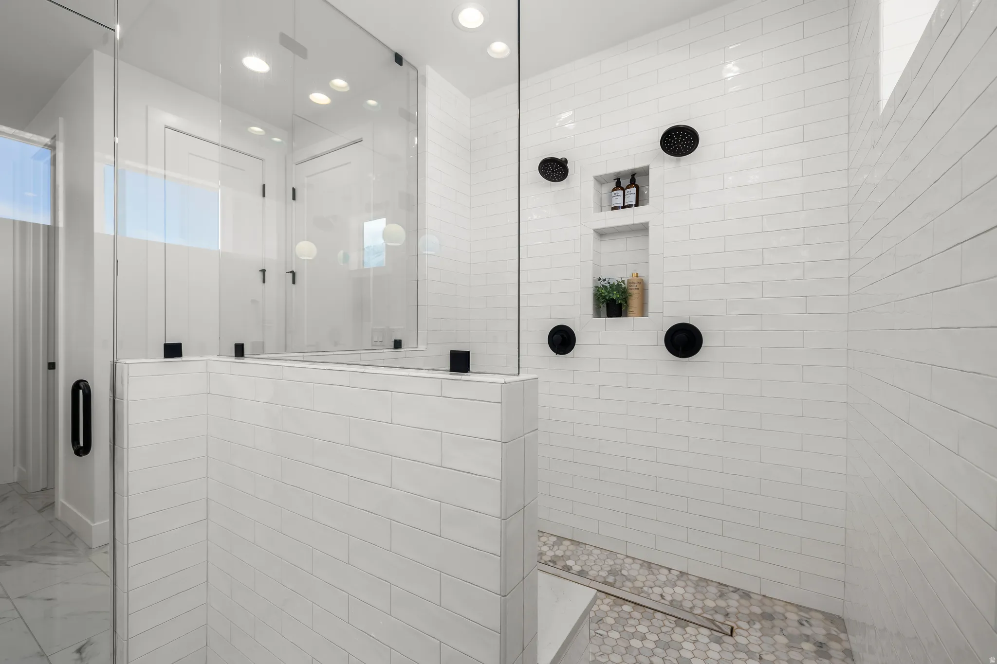 Full bathroom with tiled shower and recessed lighting