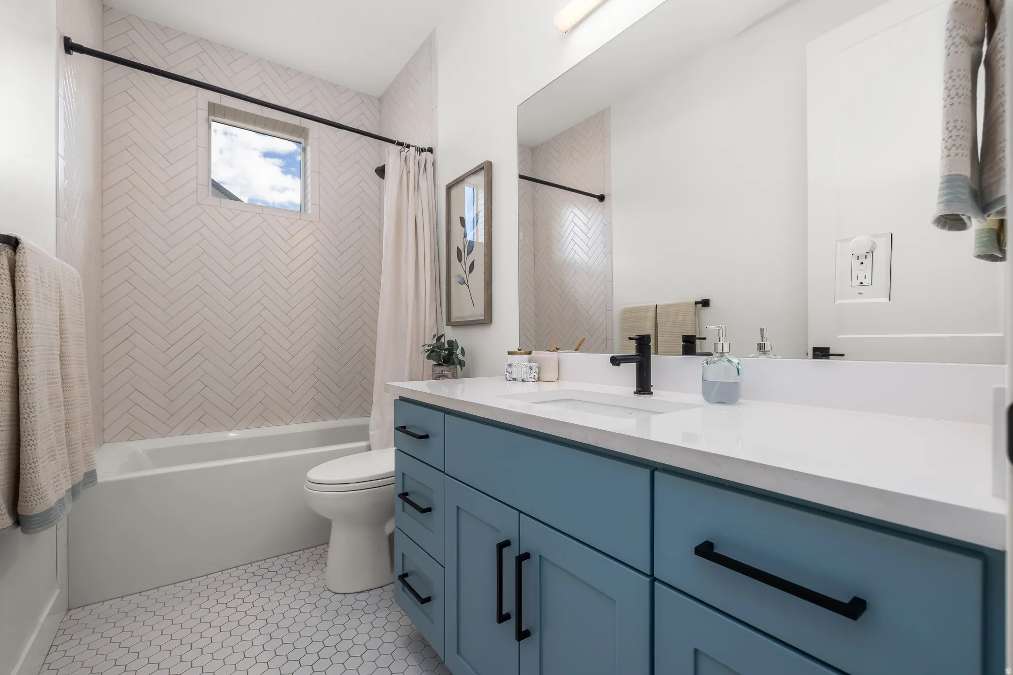 Bathroom featuring vanity, shower / tub combo with curtain, and light tile patterned floors
