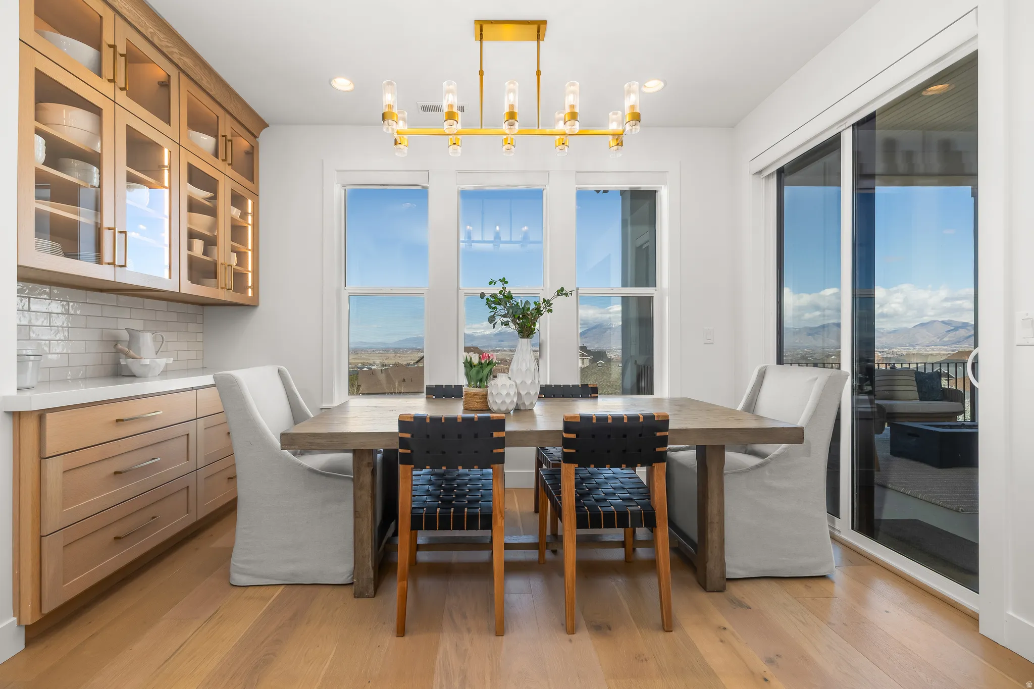 Dining room featuring light wood-style flooring, a mountain view, and a chandelier