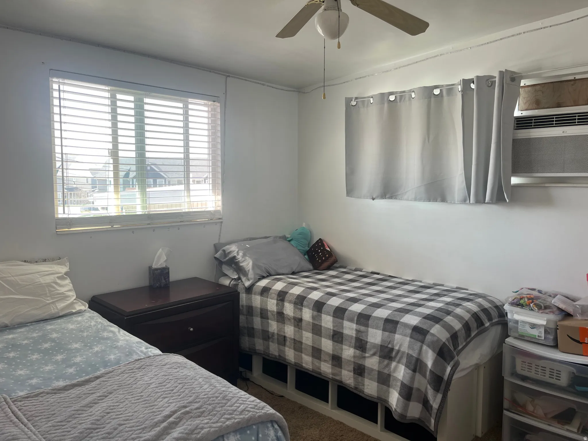 Bedroom featuring ceiling fan and carpet floors