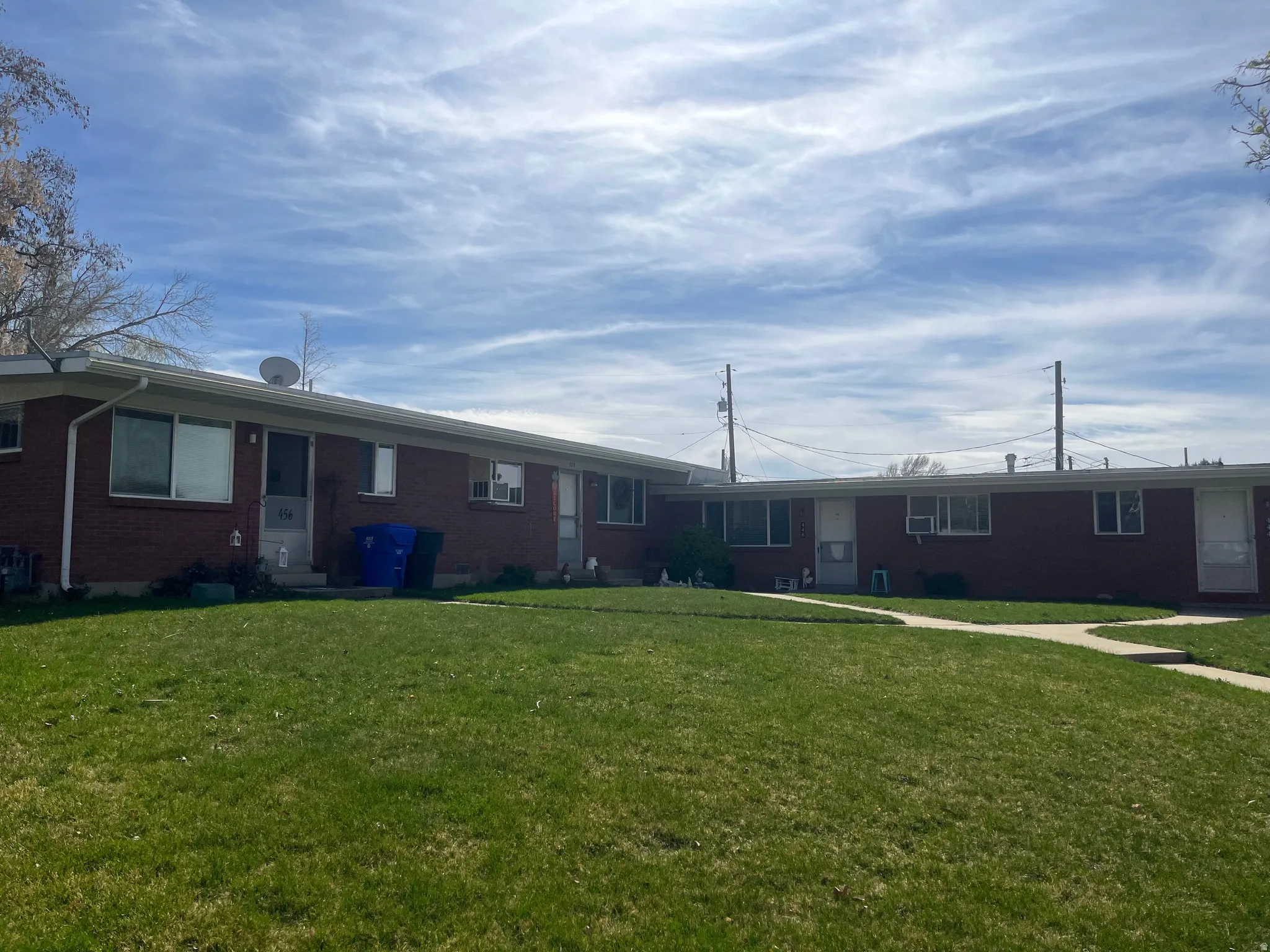 View of front of house featuring brick siding and a front lawn